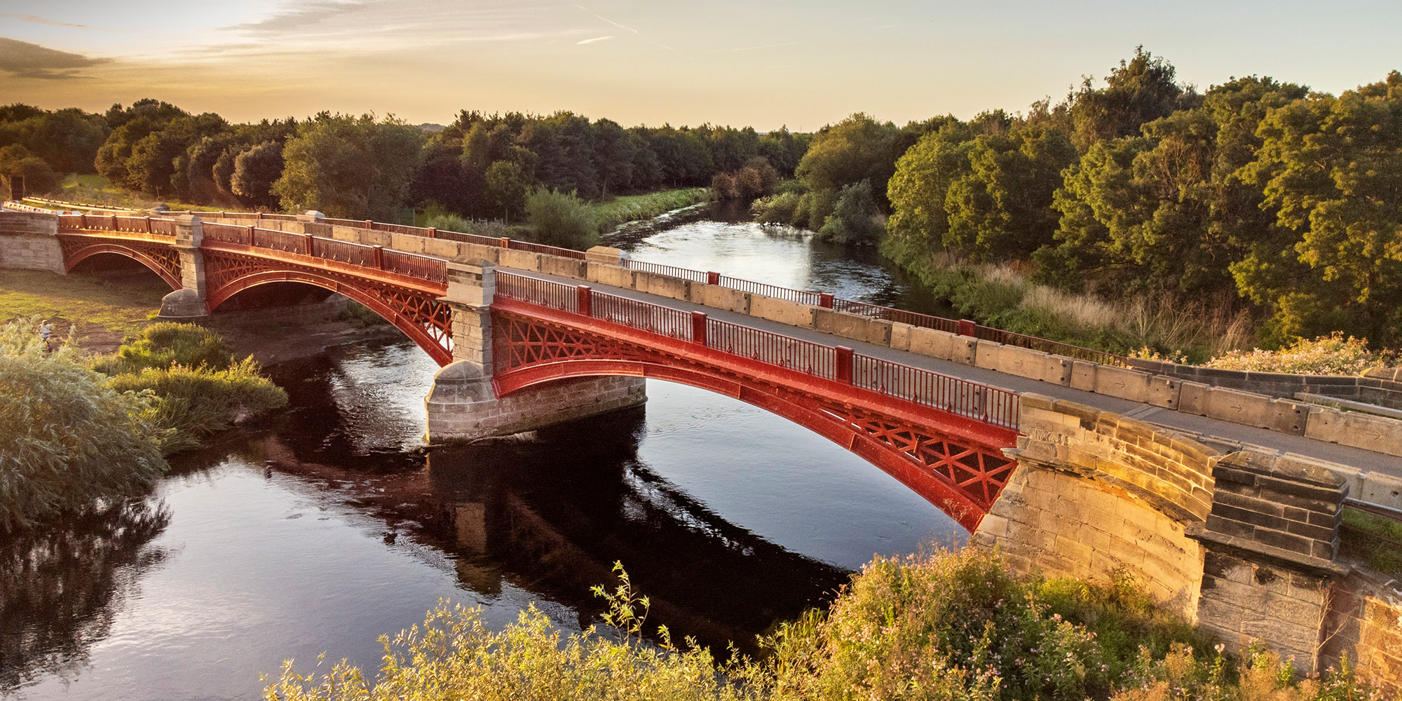 General view of cast iron and rusticated ashlar three segmental arched bridge. 