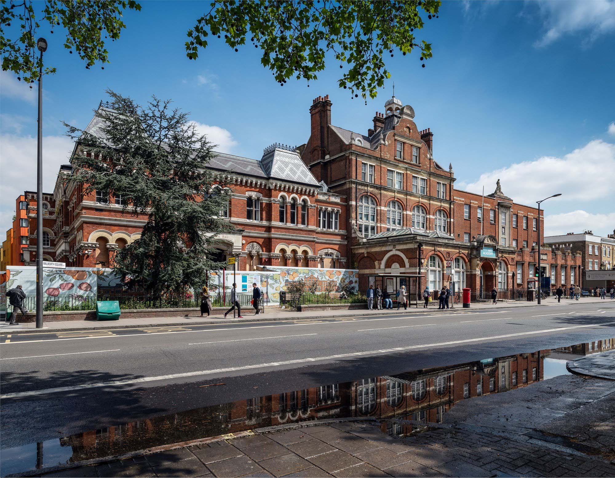  A general view of a building with people walking on the street

