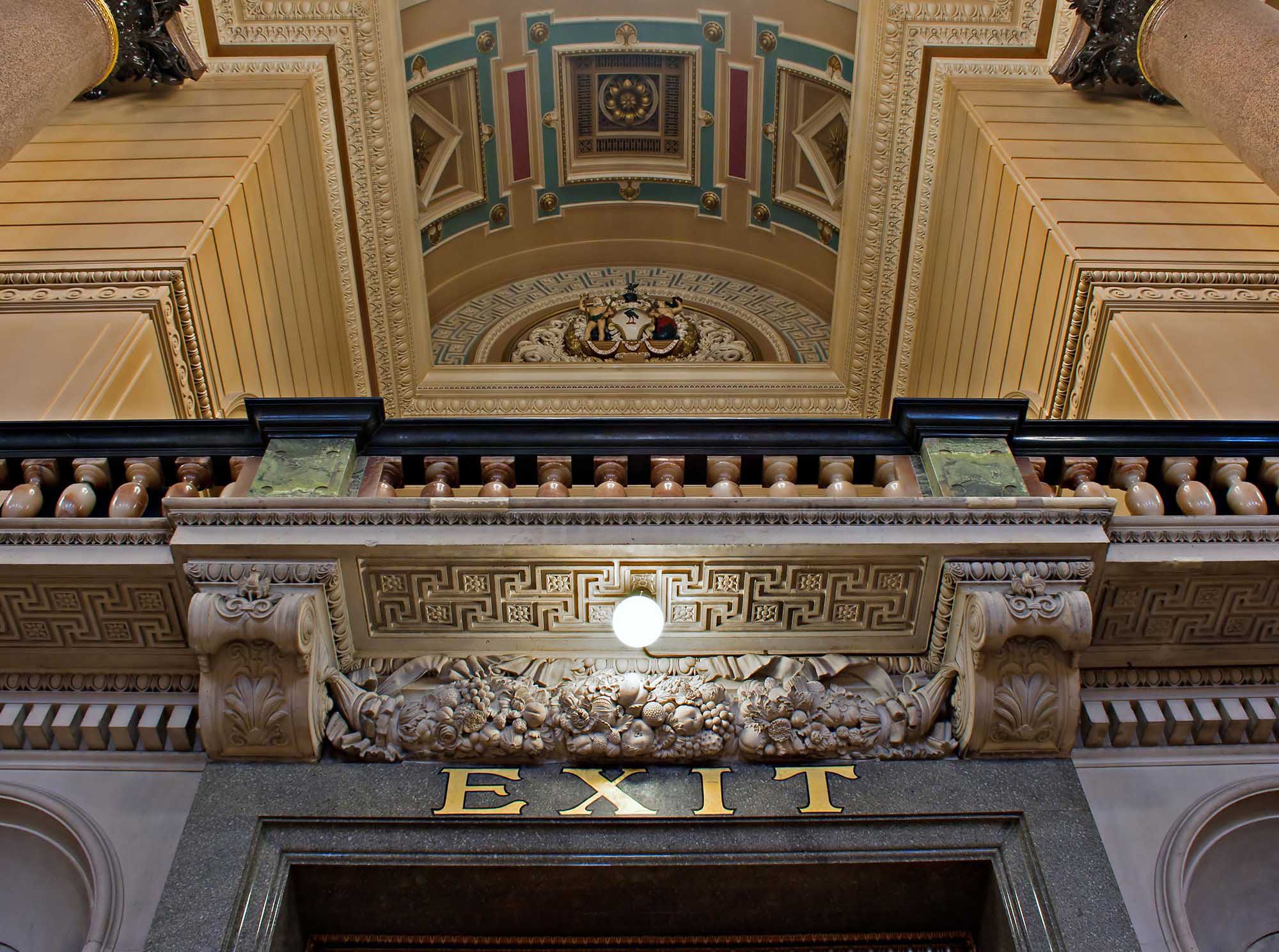 EXIT sign in gold letters above a doorway