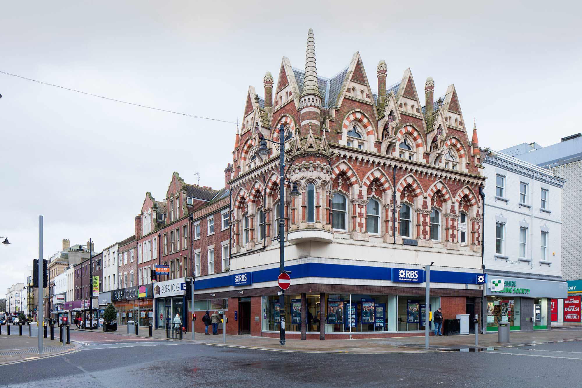 Building on corner of road with decorative brickwork