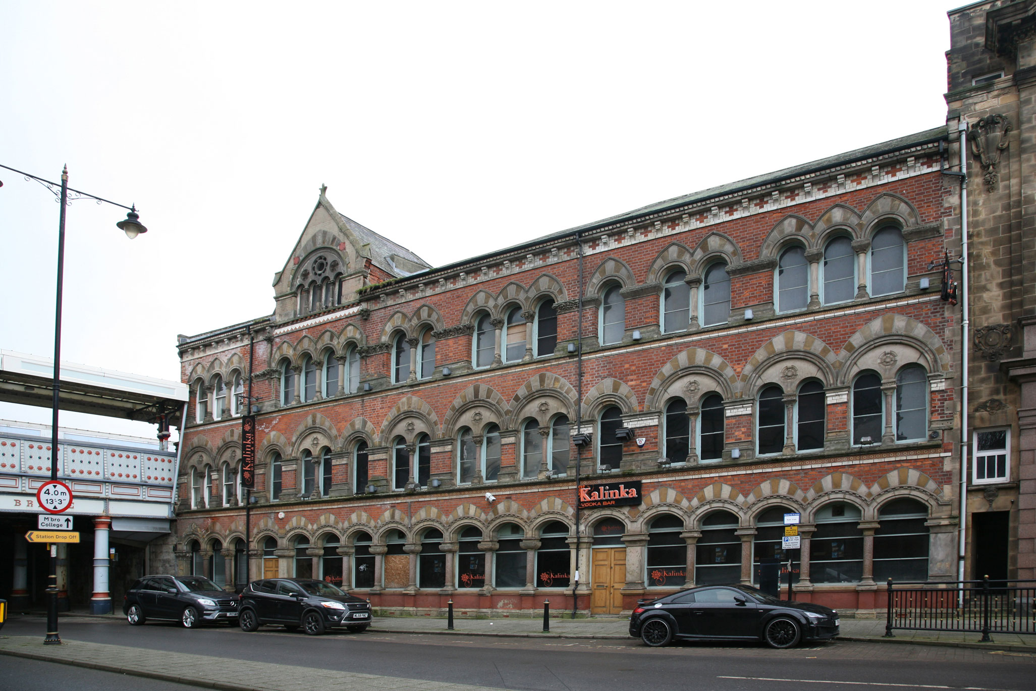 Elevation of a three storey Victorian Gothic style brick building.