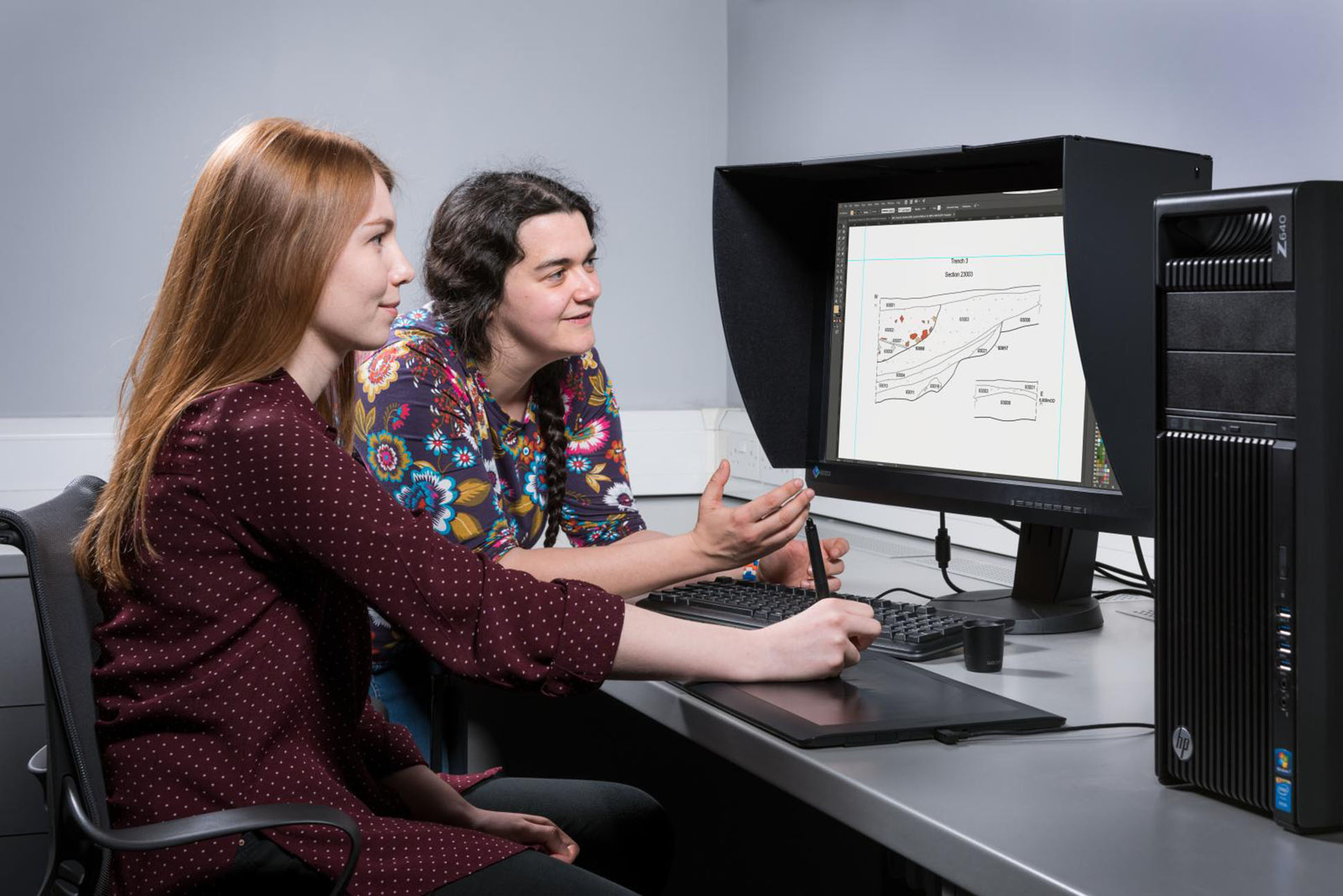 Two women looking at computer screen