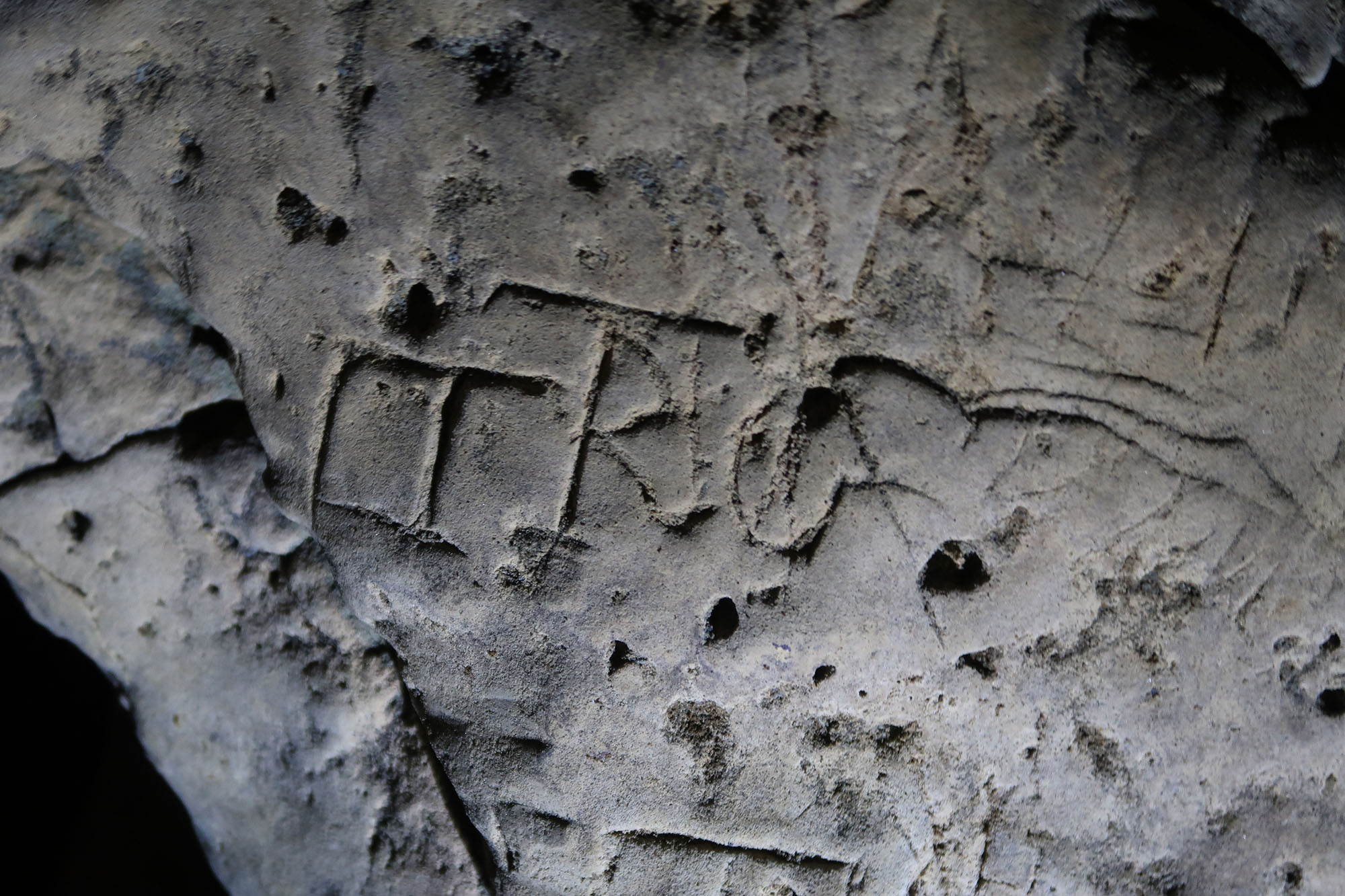 Diagonal lines and letters are engaved here.