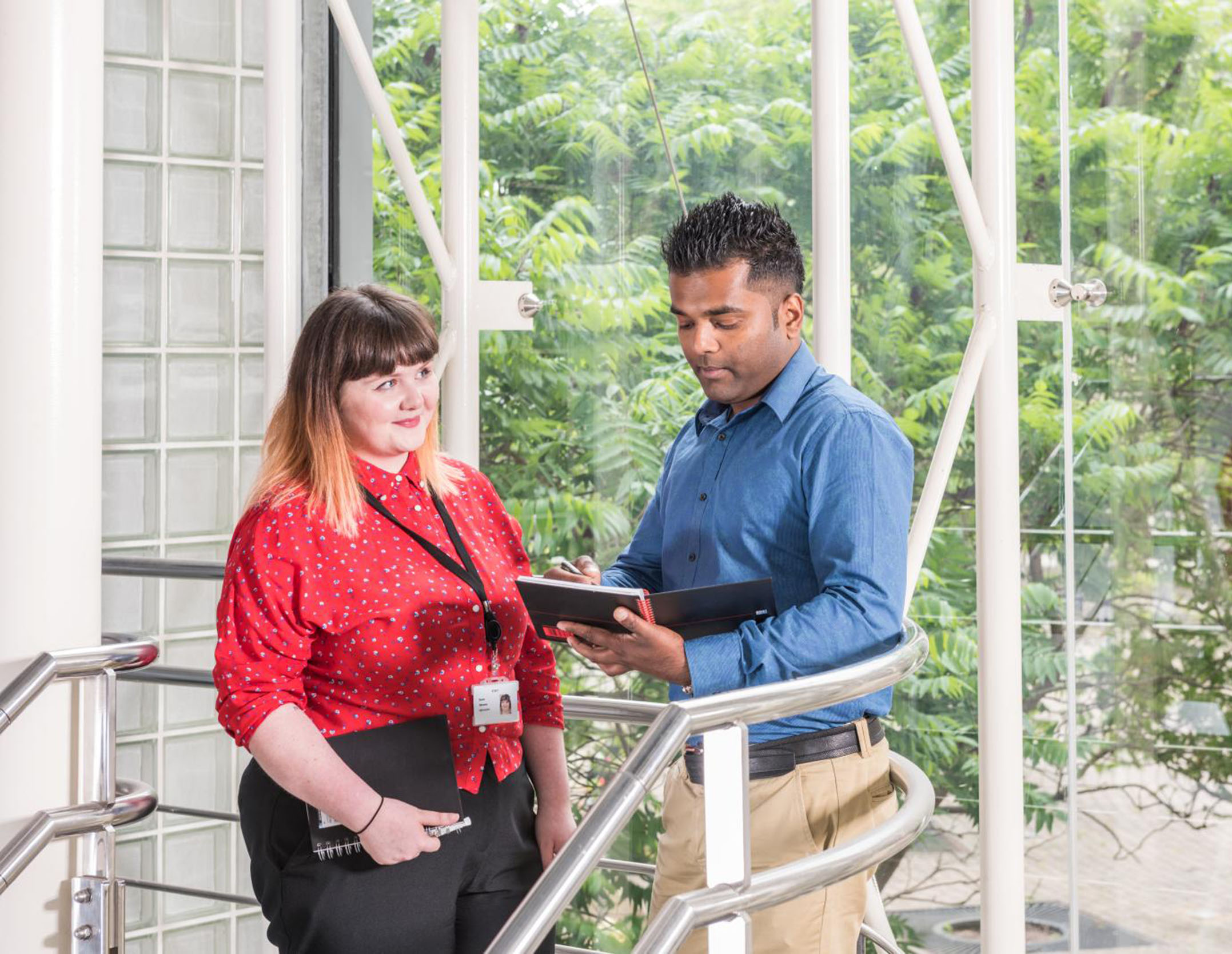 Two Historic England employees standing and talking in the office at the Engine House, Swindon.