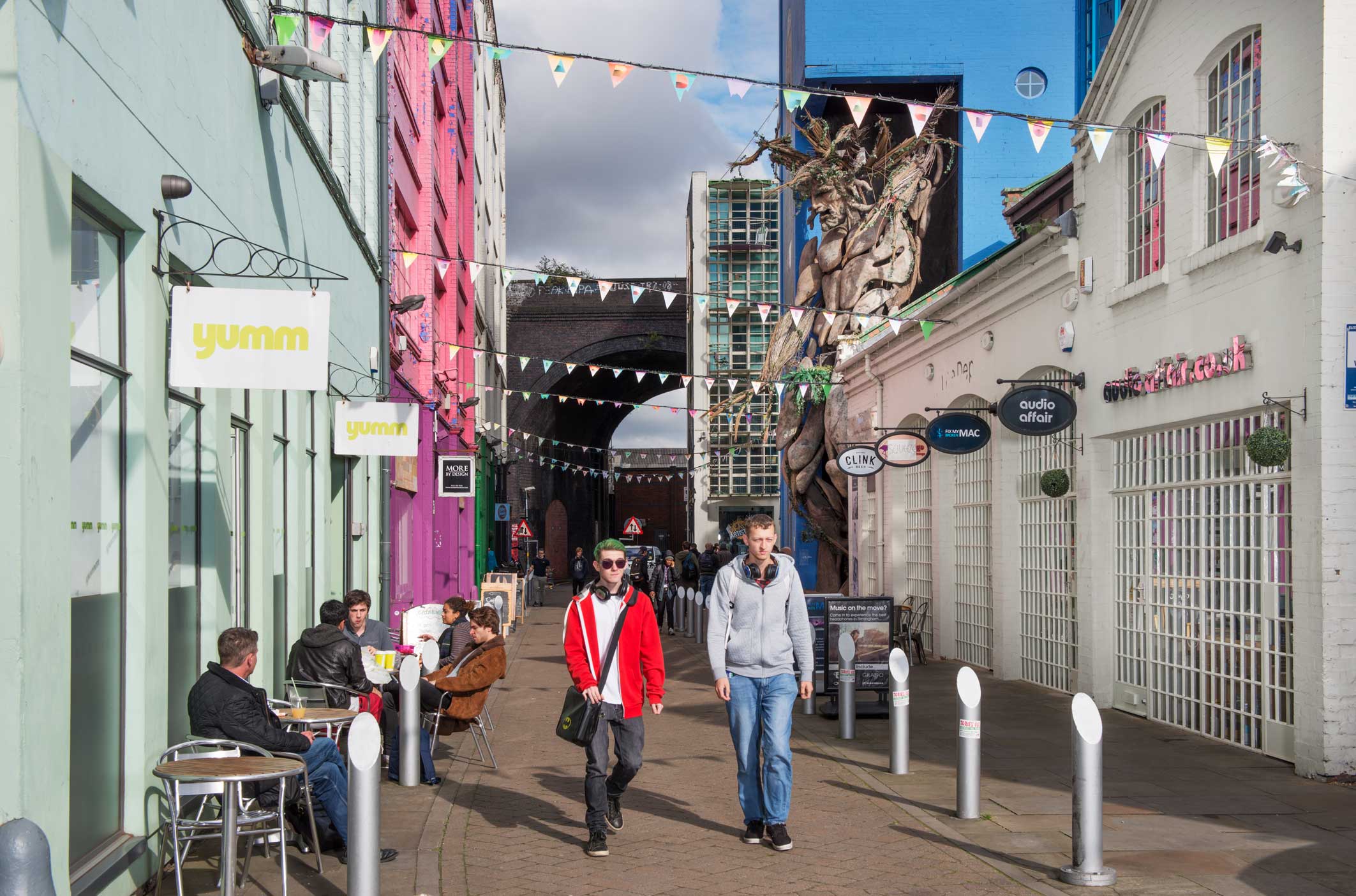 People enjoying cafes in the regenerated Custard Factory complex in Digbeth.