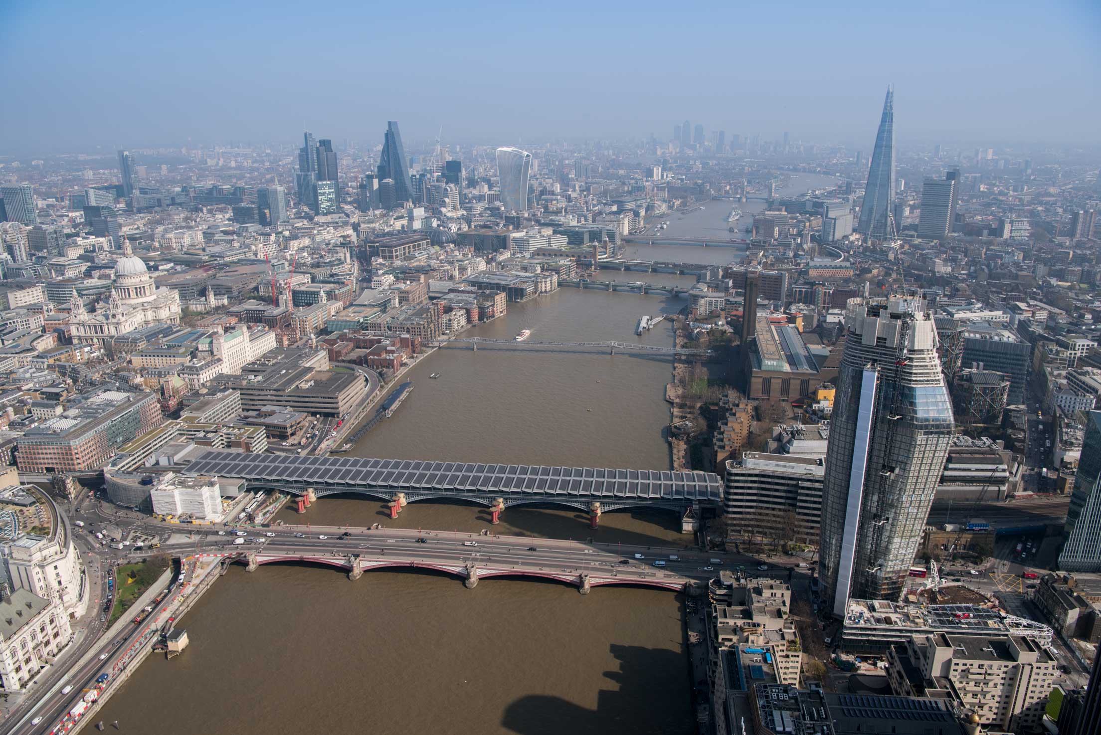 An areal view of central London along the Thames including St Pauls.