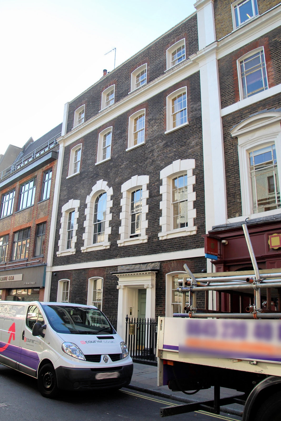 Georgian building with rusticated window surrounds.