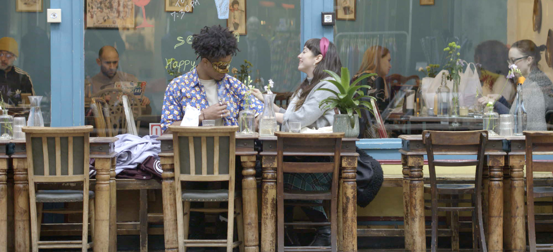 A couple sitting outside Brixton Market