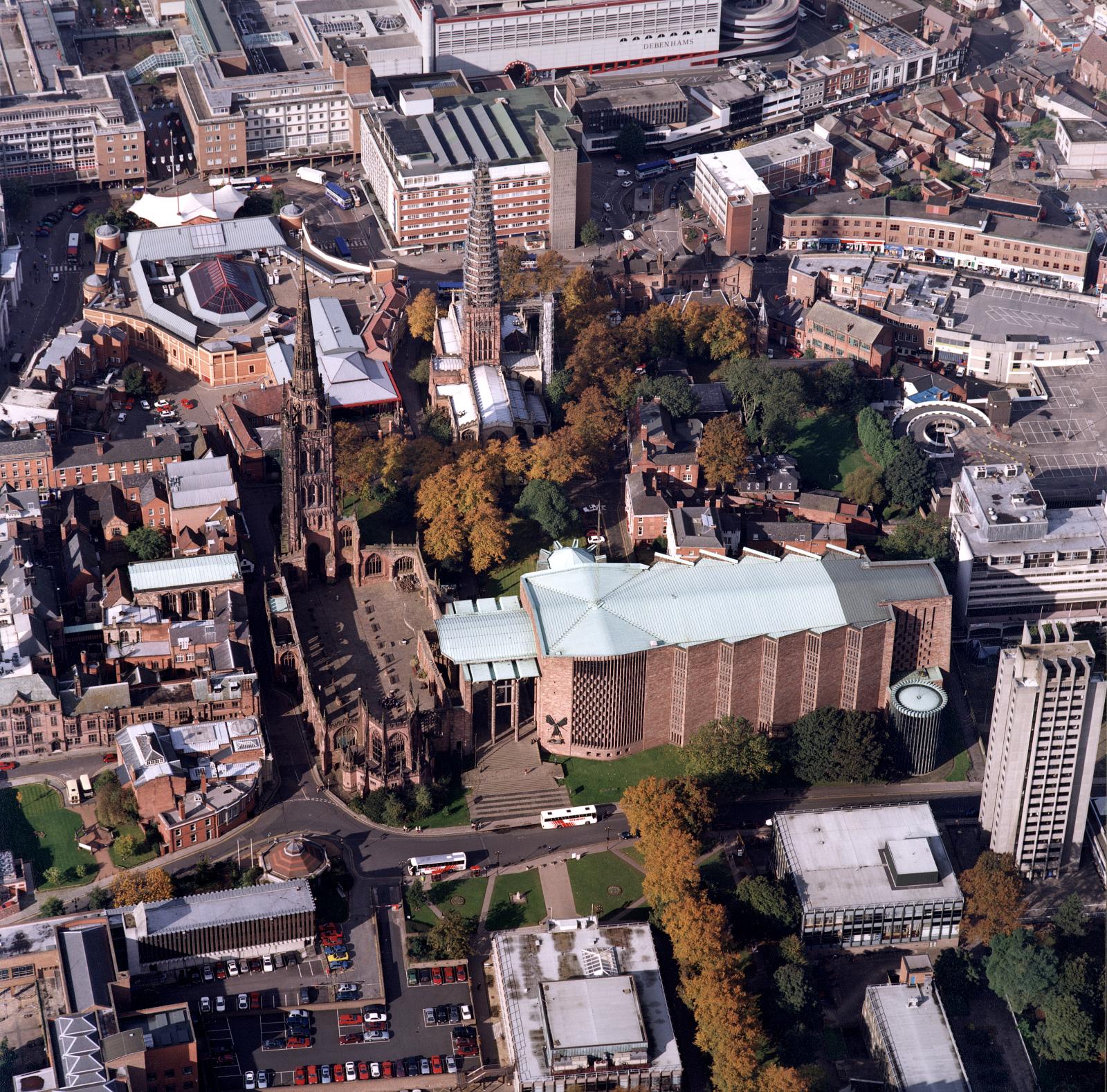 From the air the interior of the old roofless cathedral can be seen to the left of the new cathedral building built in the 1950s.
