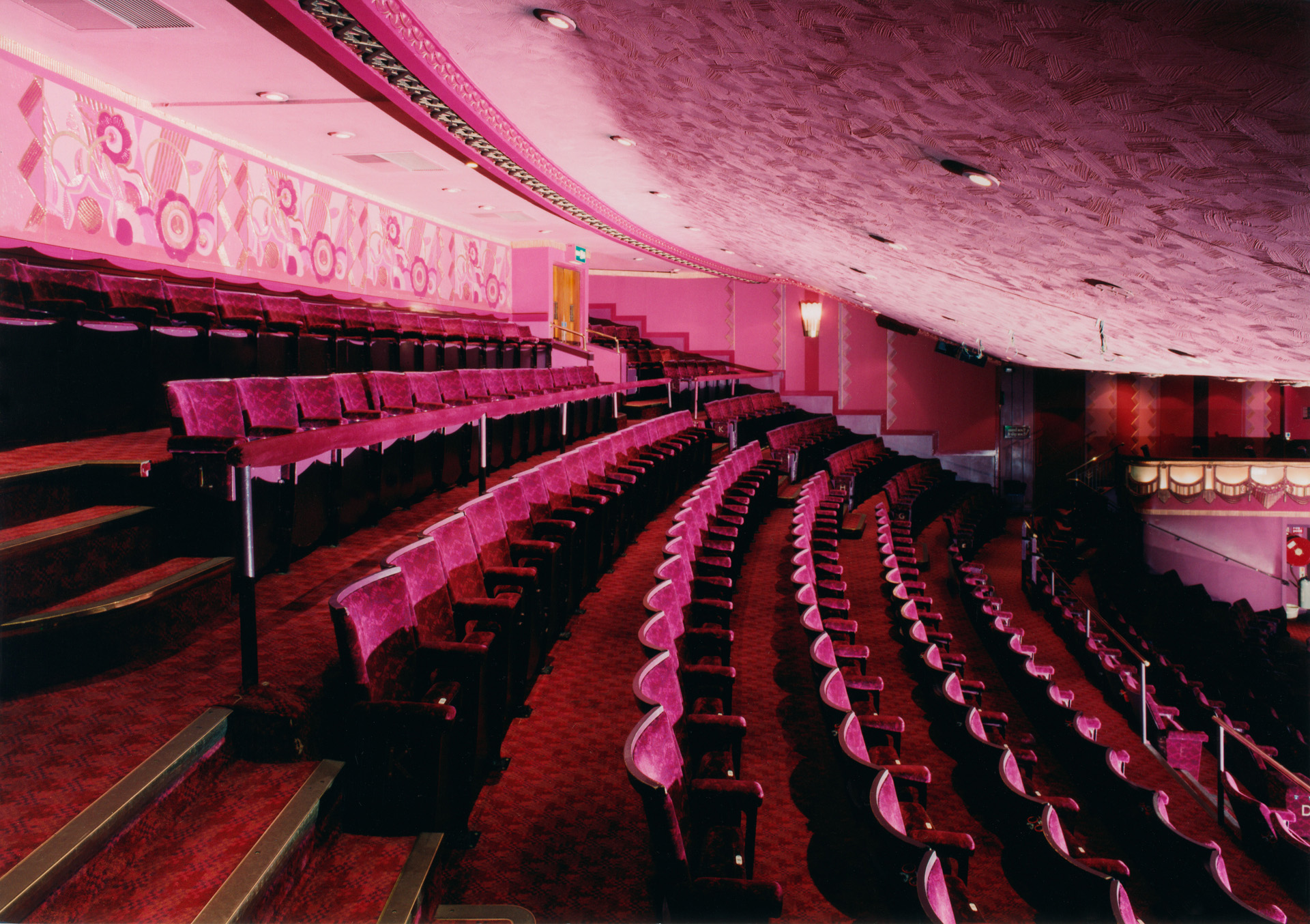 Interior of Prince Edward Theatre, London.  View of auditotrium at dress circle level, across seating showing rake. 