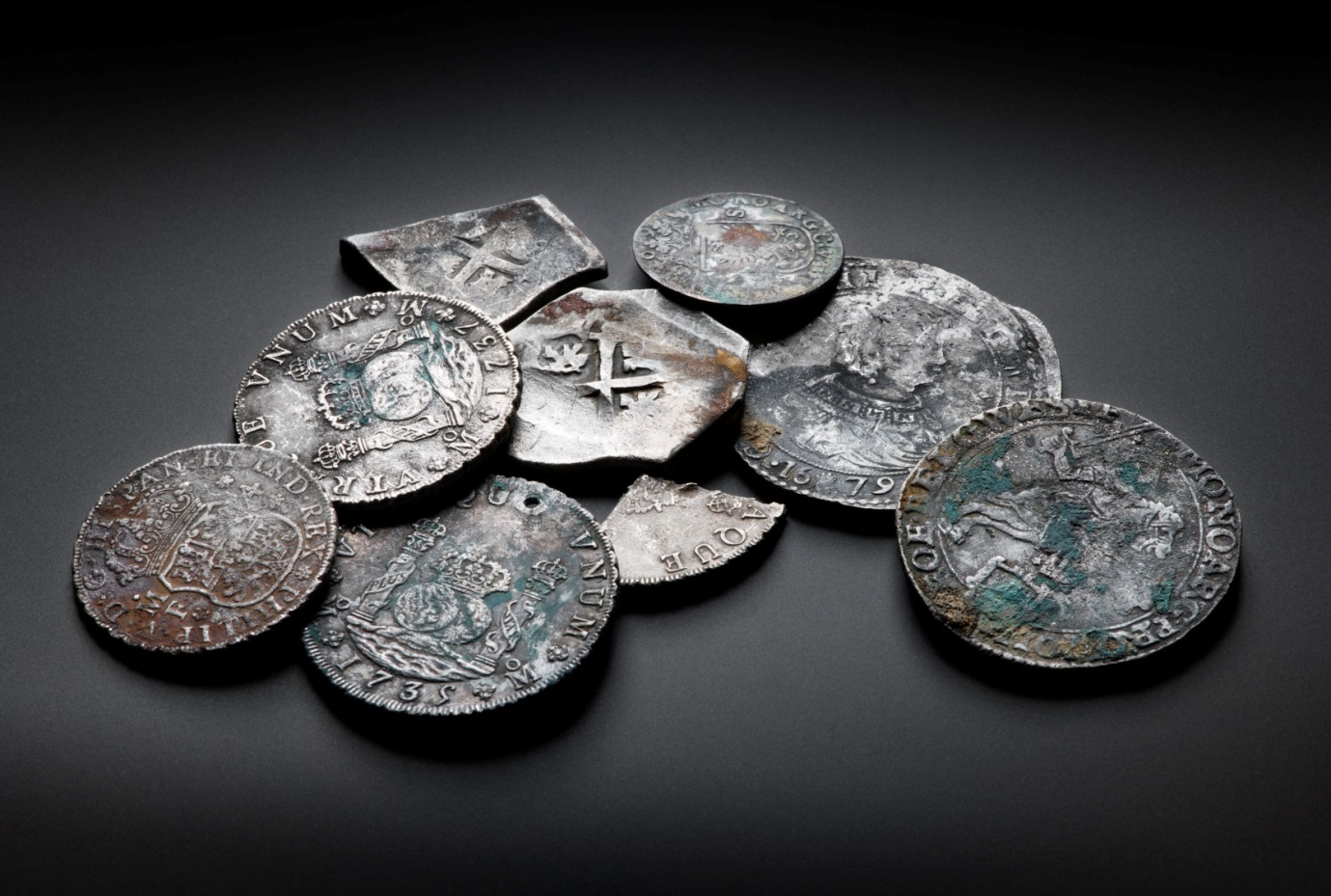 A selection of silver coins, including some snipped fragments.
