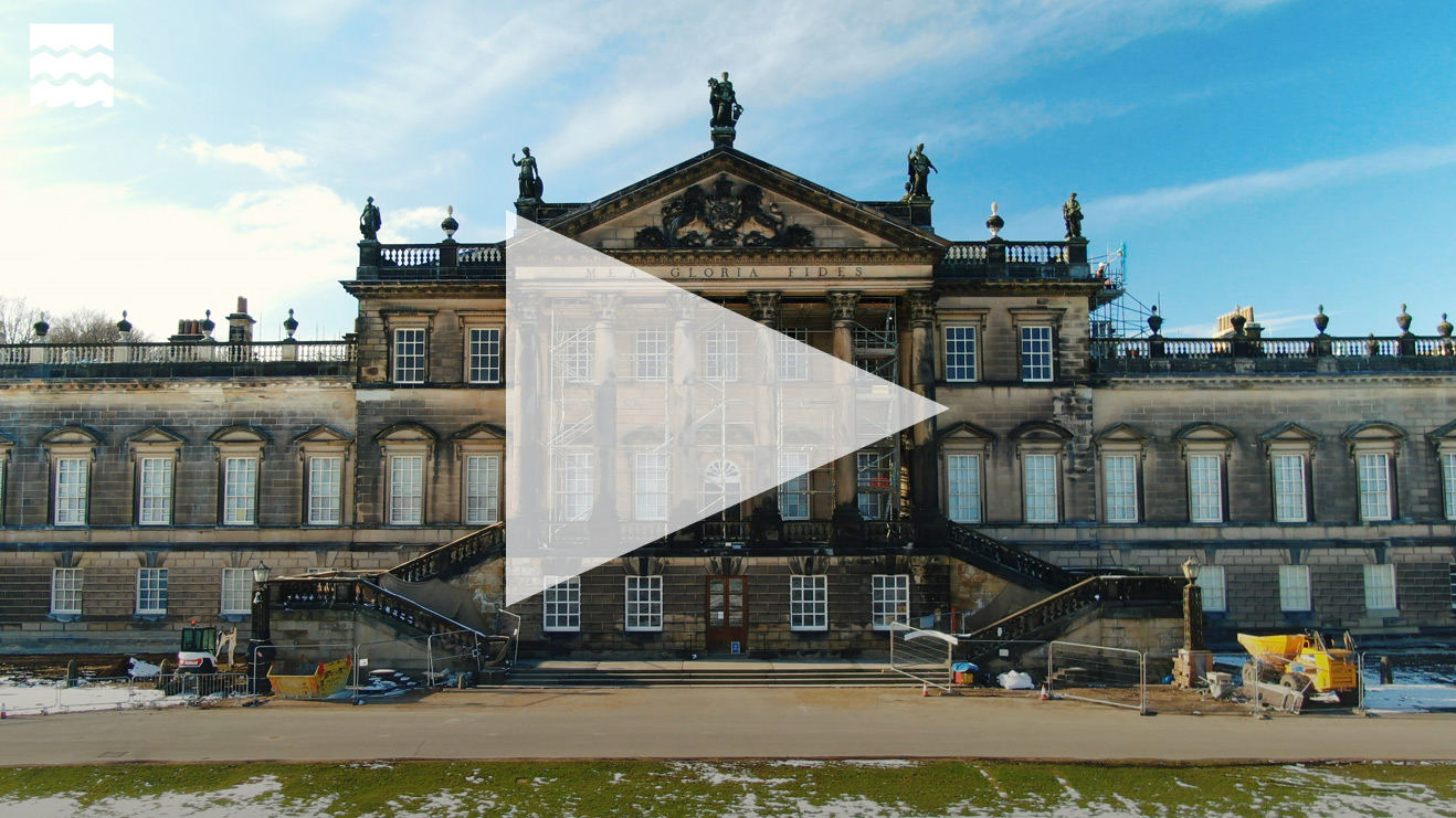 Front facade of Wentworth Woodhouse with diggers and skips outside