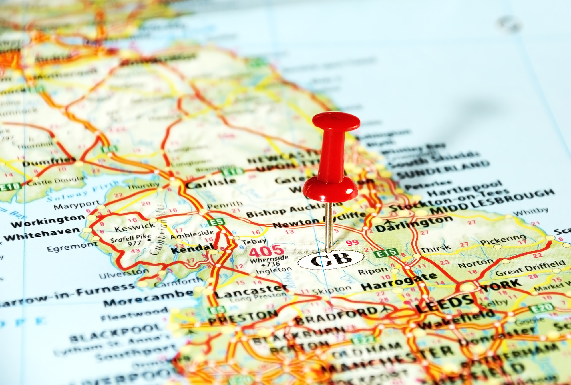 Photo of part of a map of Britain (from Sheffield up to Dumfries) with a pin stuck in marking a spot in the Pennines.