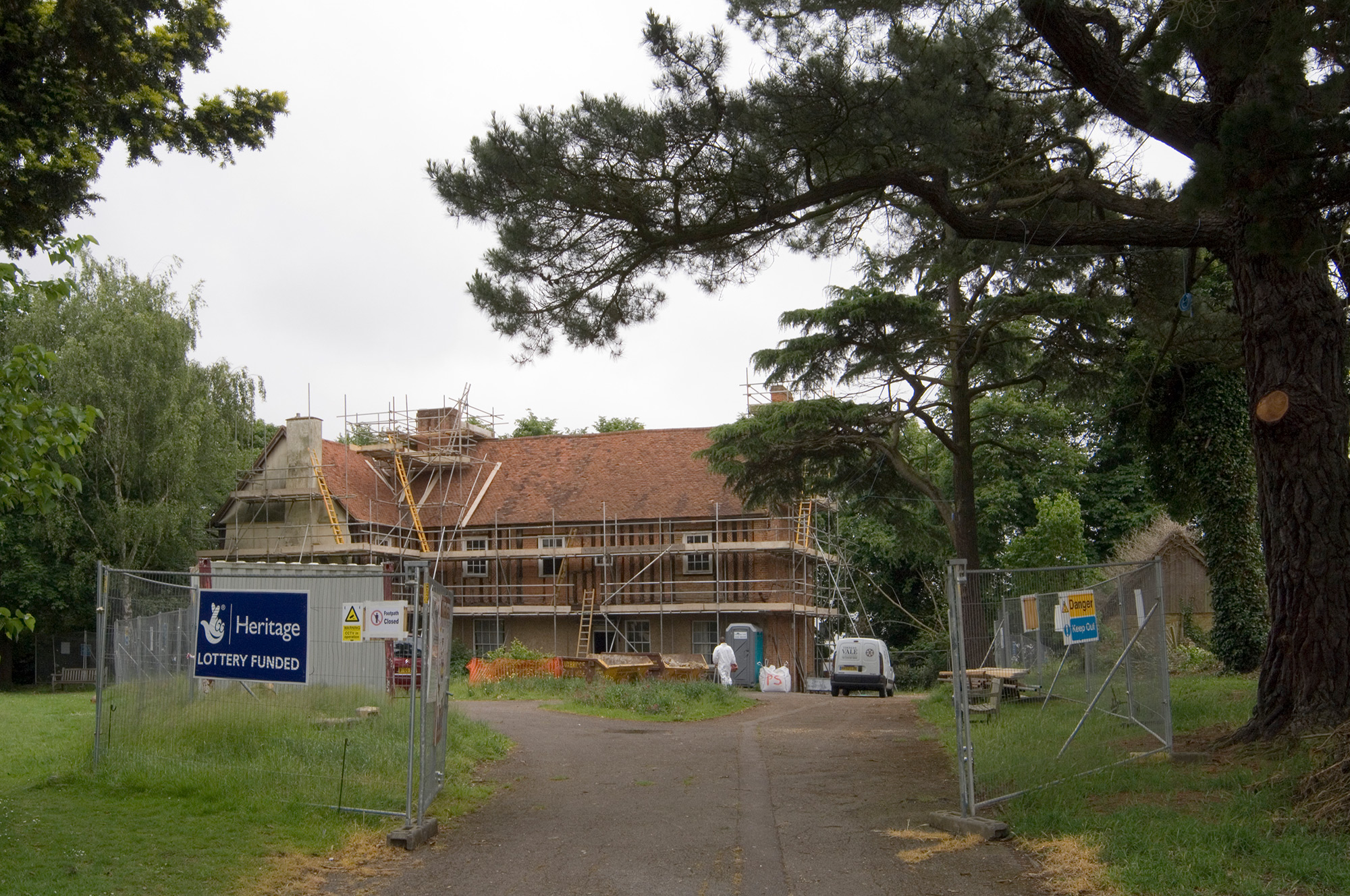 A building covered in scaffolding and a Heritage Lottery Funded sign on a temporary fence.