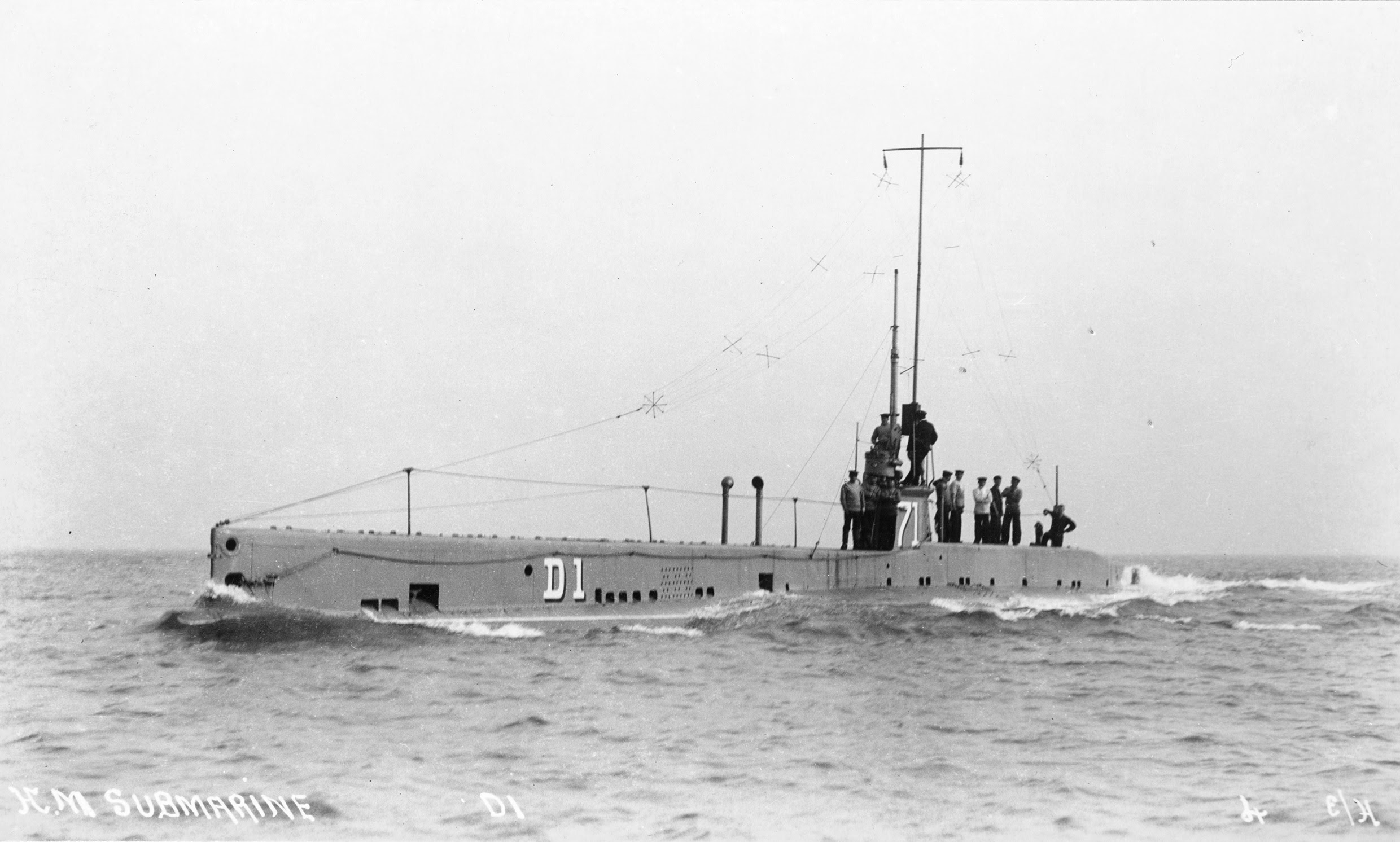 Sailors standing on a submarine at sea