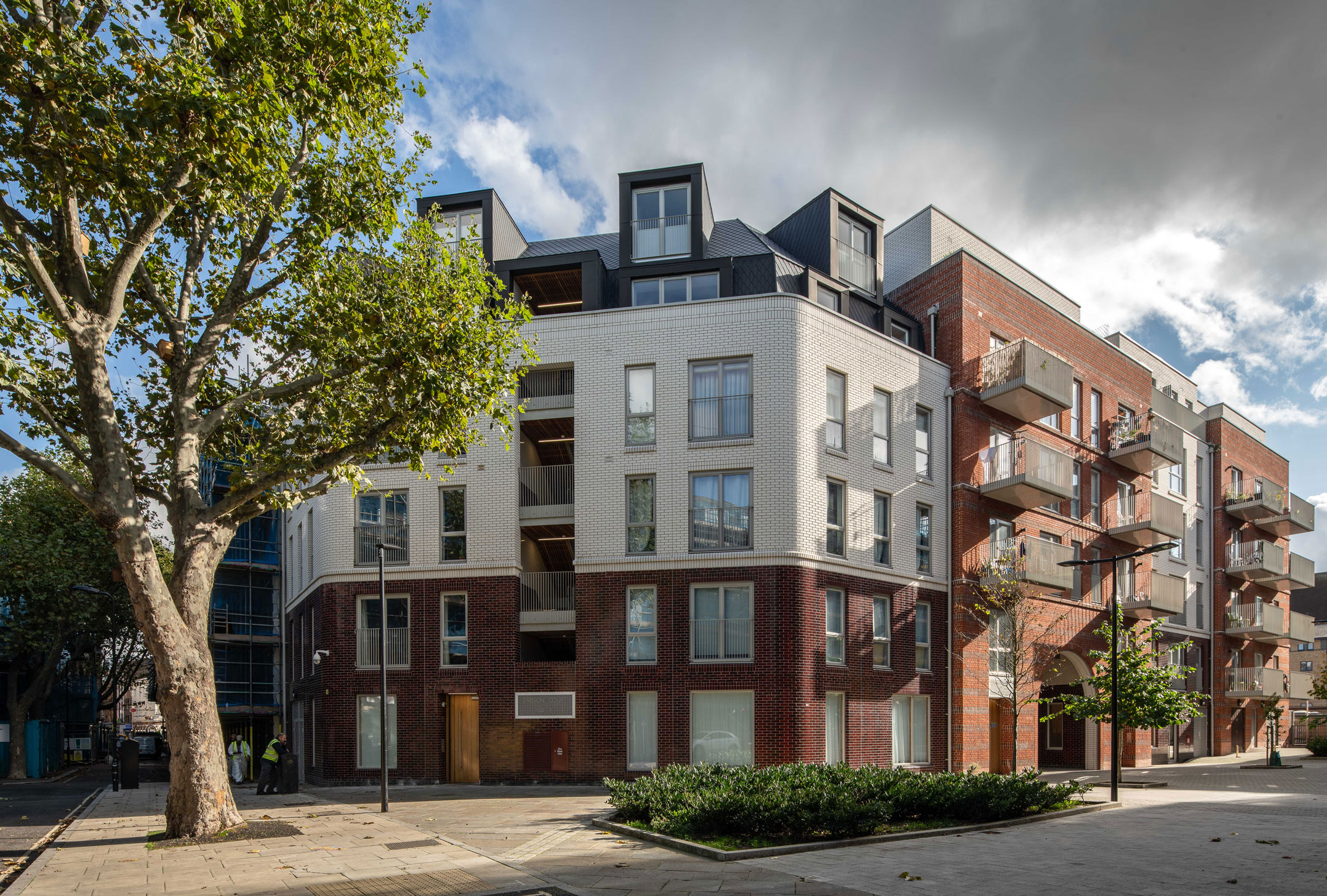 An exterior view of low-rise hosing blocks at a small London estate.