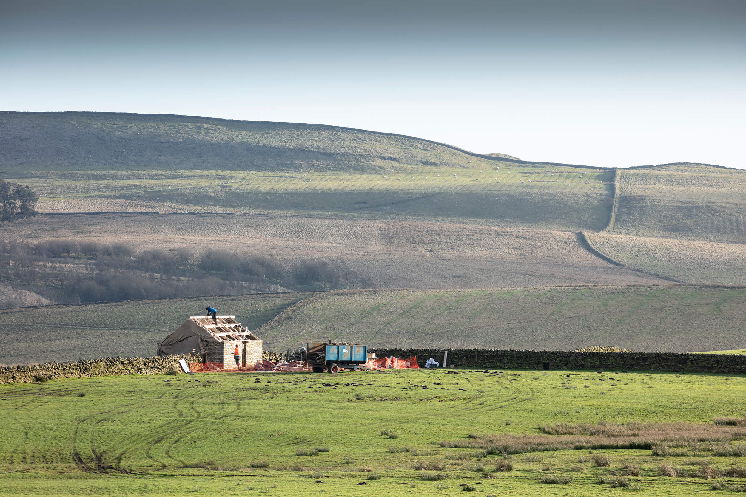 Roof repairs underway on a rural barn.