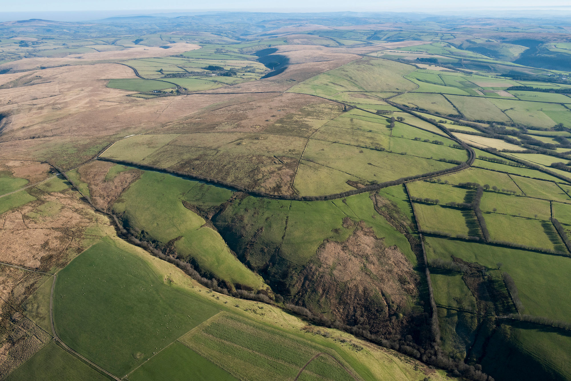An aerial view of a hilly moorland landscape.