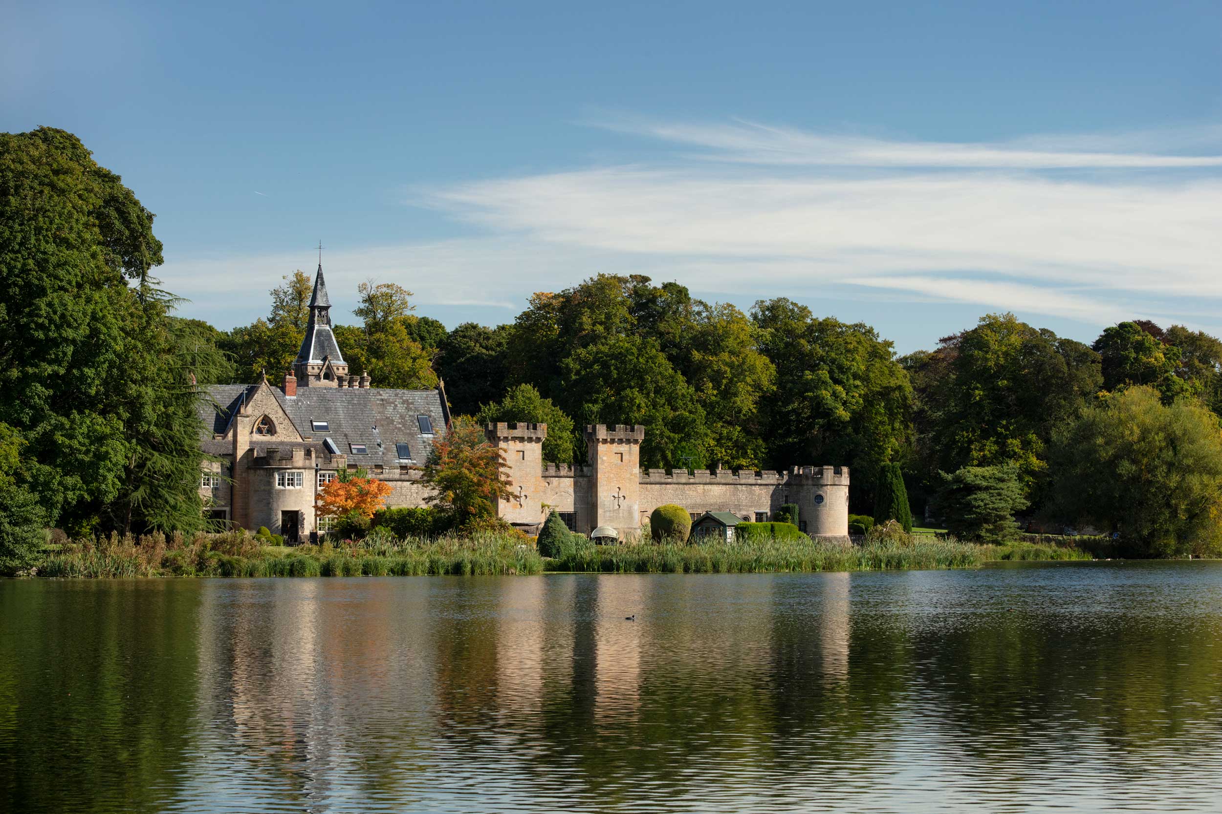 Cannon Fort and surrounding trees viewed across a lake.