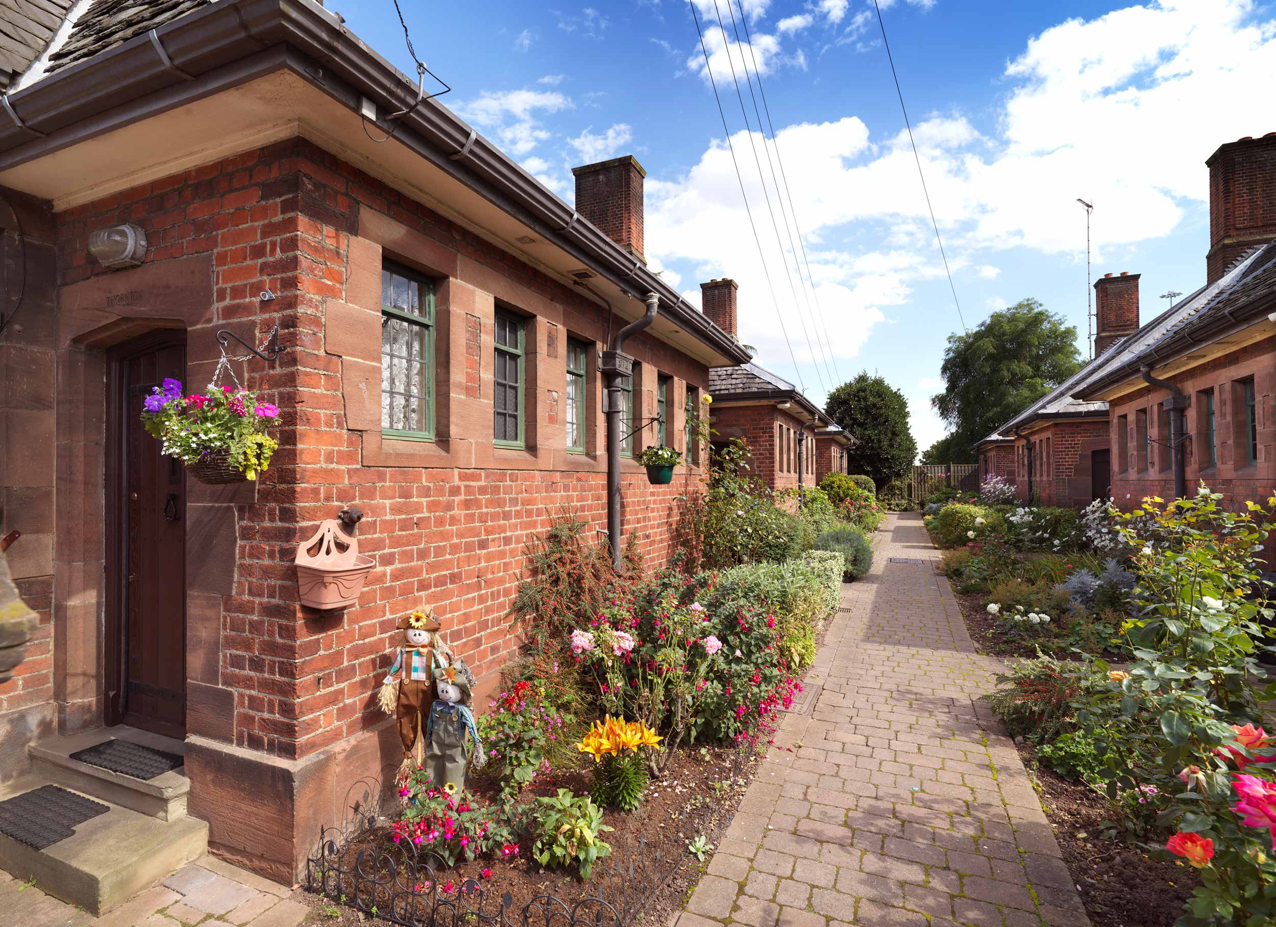 General view of almshouses and well-tended gardens.