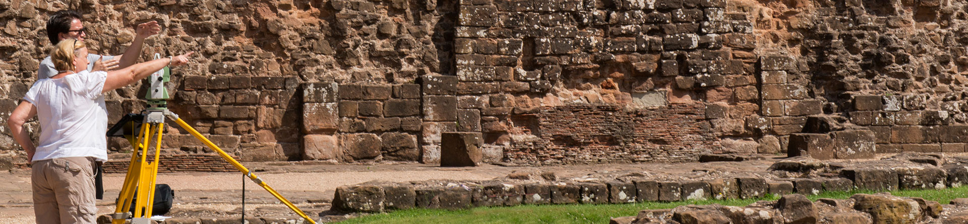 Member of staff teaching surveying at Kenilworth Castle as part of the Historic England Metric Survey School