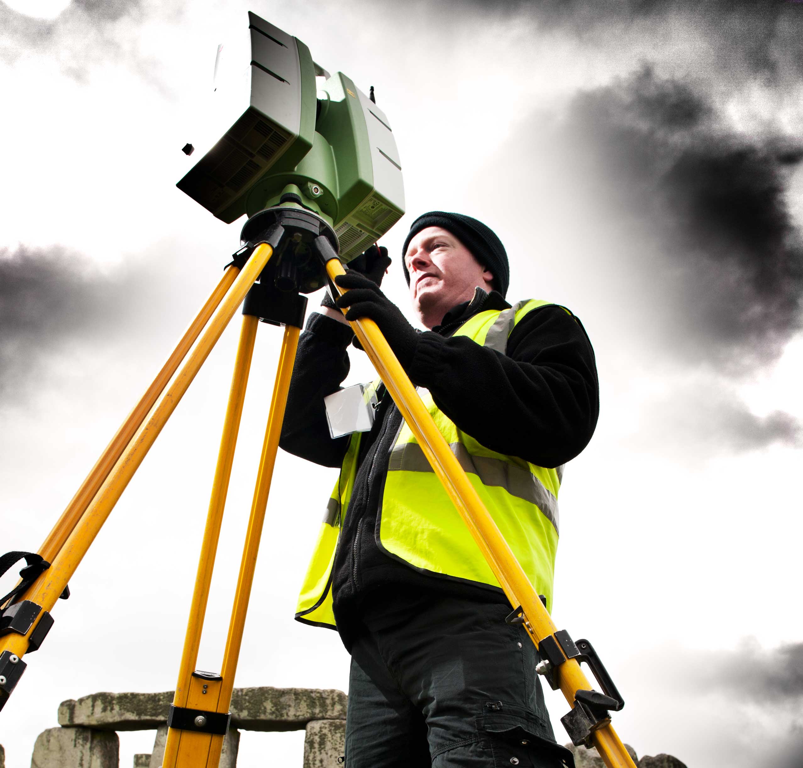 A man using laser scanning equipment at Stonehenge.