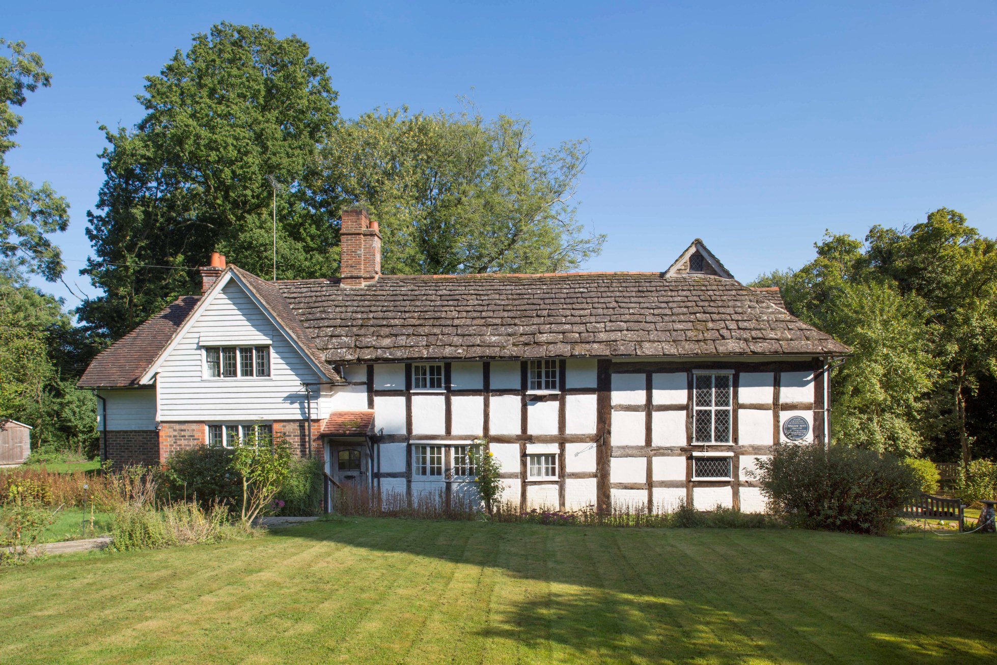 Blue Idol Quaker Meeting House, West Sussex, view from west showing timber-framed soulth range and weather-boarded west-facing gable above later brick bay.