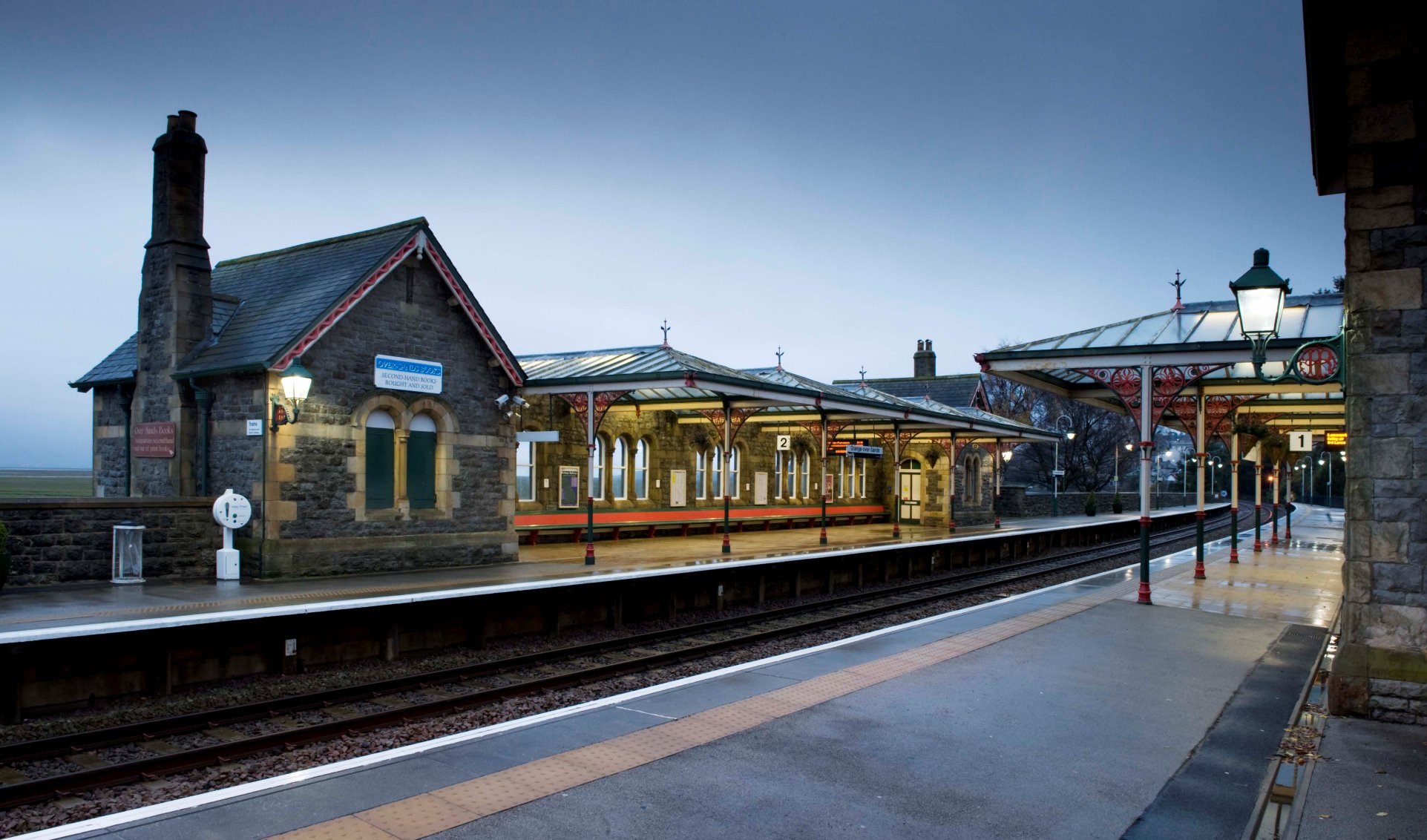 Iron and glass station canopies seen by night.