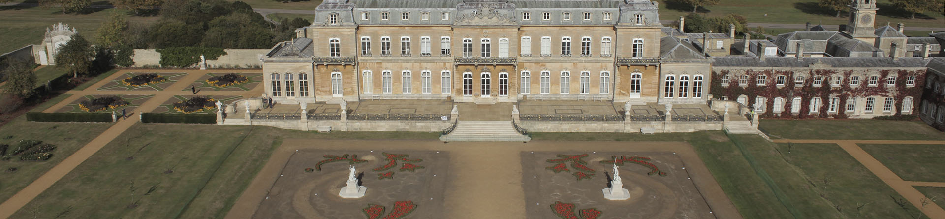 Large house in the background with a designed garden in the foreground