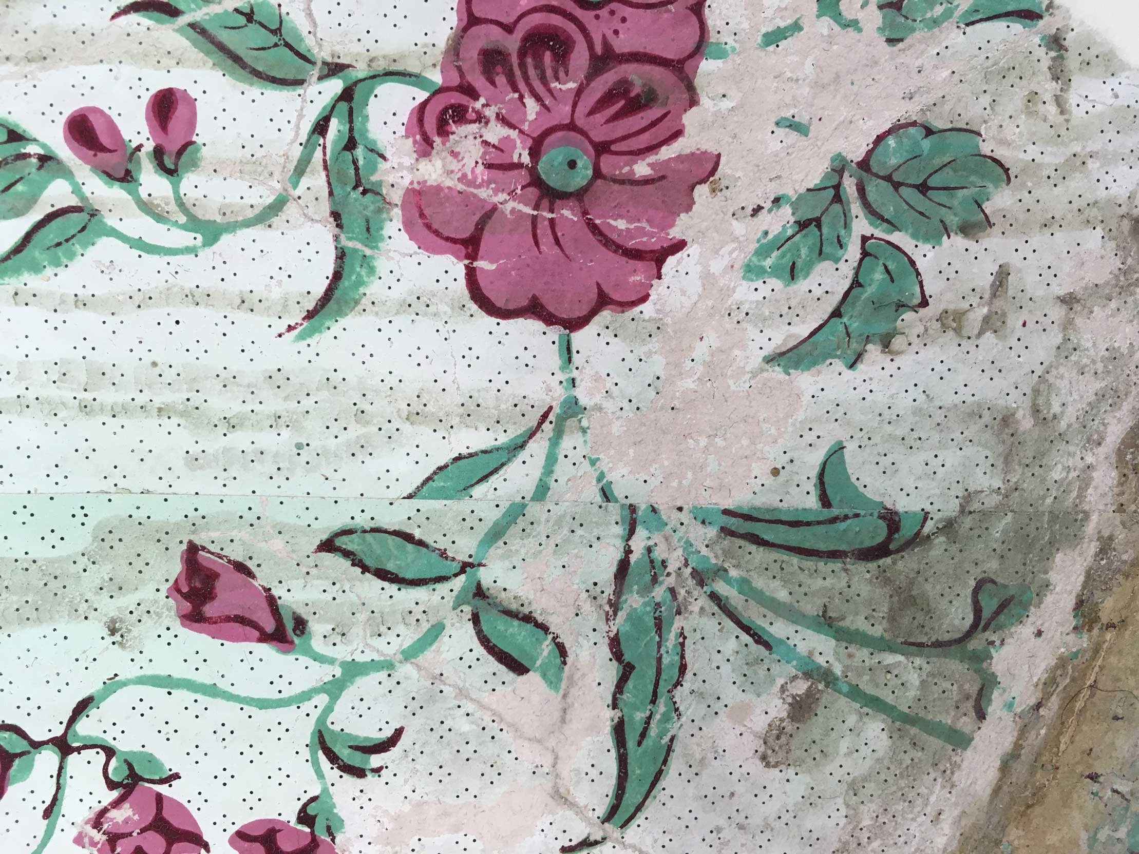 Detail of historic wallpaper with a floral pattern.