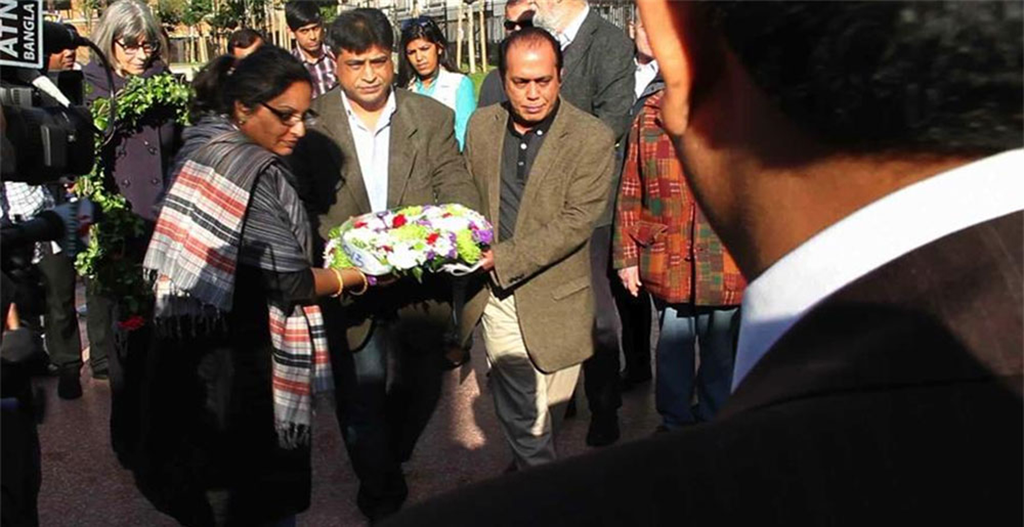 A group of people carrying wreaths.