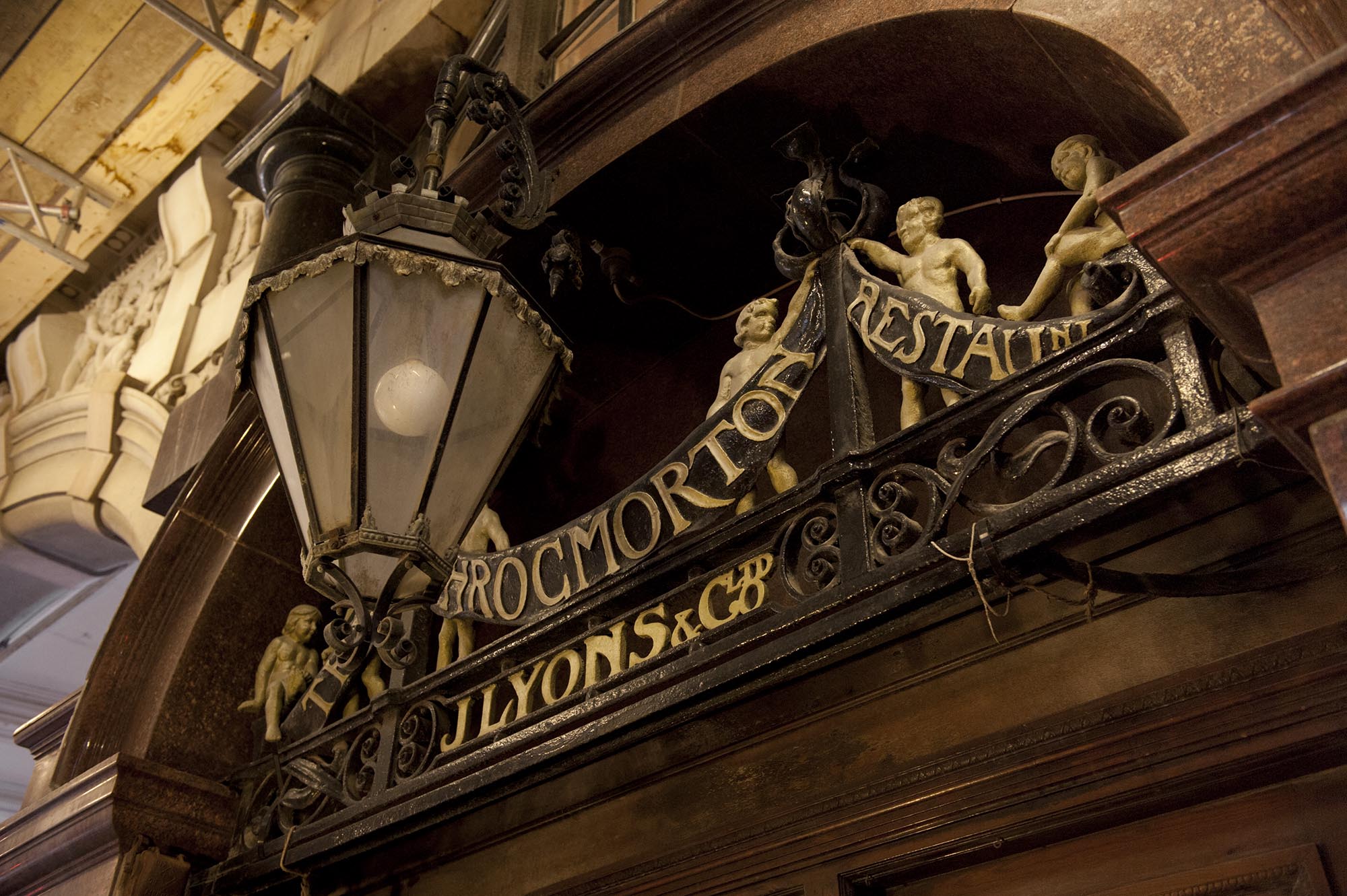 Detail of the signage for J Lyon's Throgmorton Restaurant and street lamp