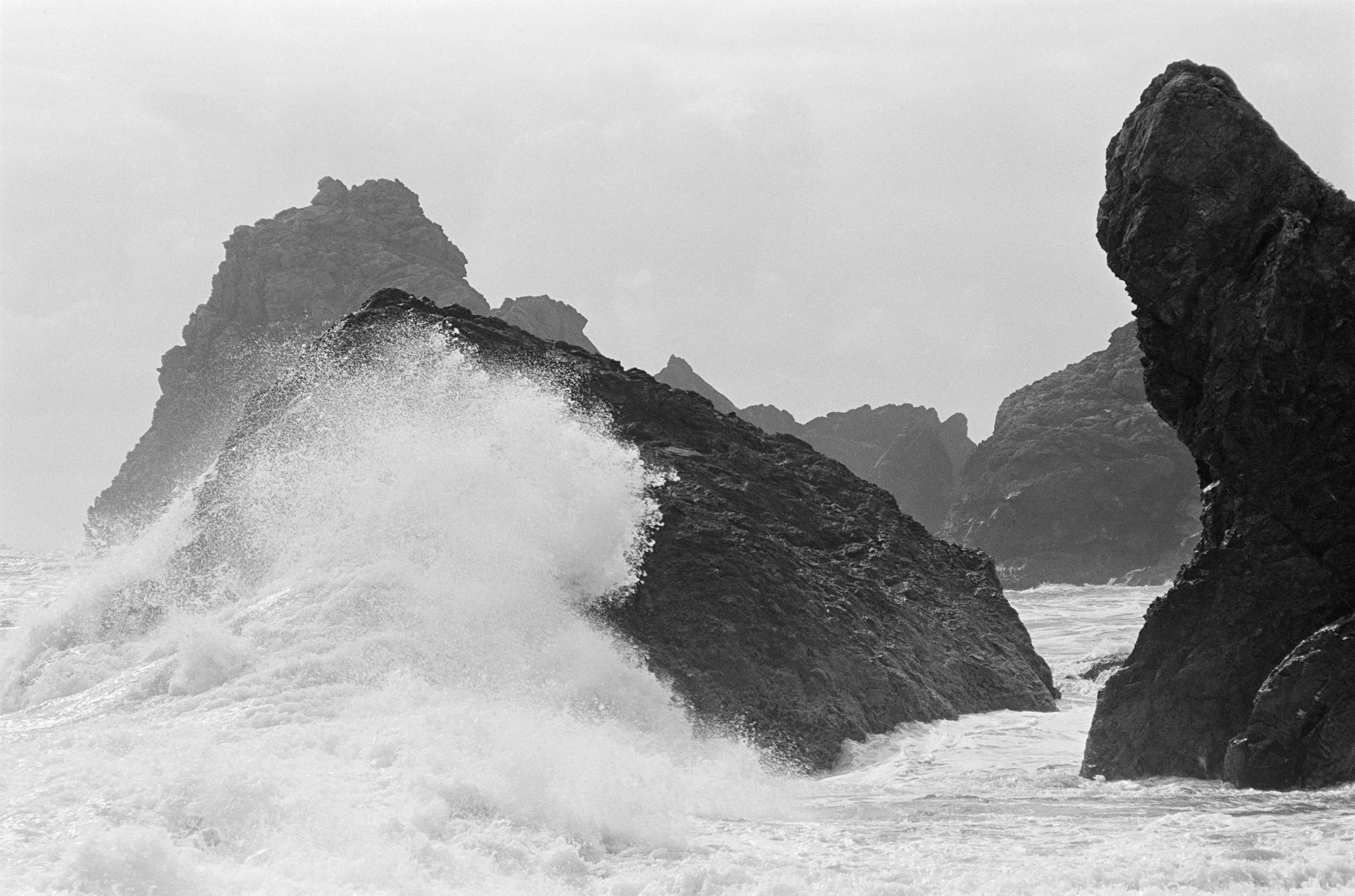 Waves crashing over rocky outcrops