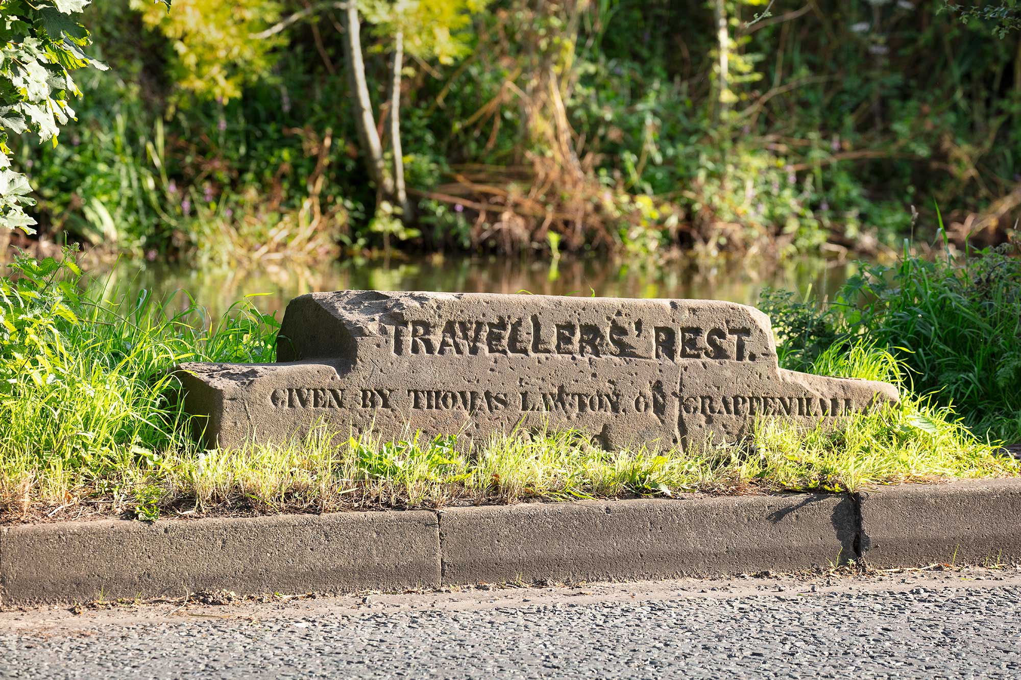 Stepped stone slab with the inscription 'Travellers' Rest / given by Thomas Lawton of Grappenhall / 1859'