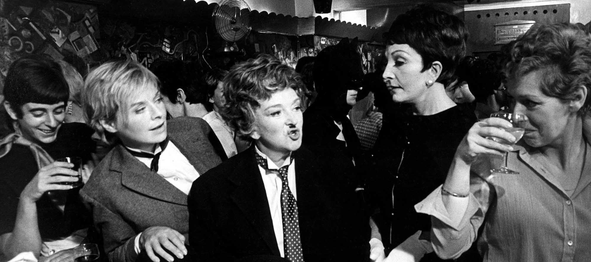 Film still from The Killing of Sister George showing people drinking at a bar