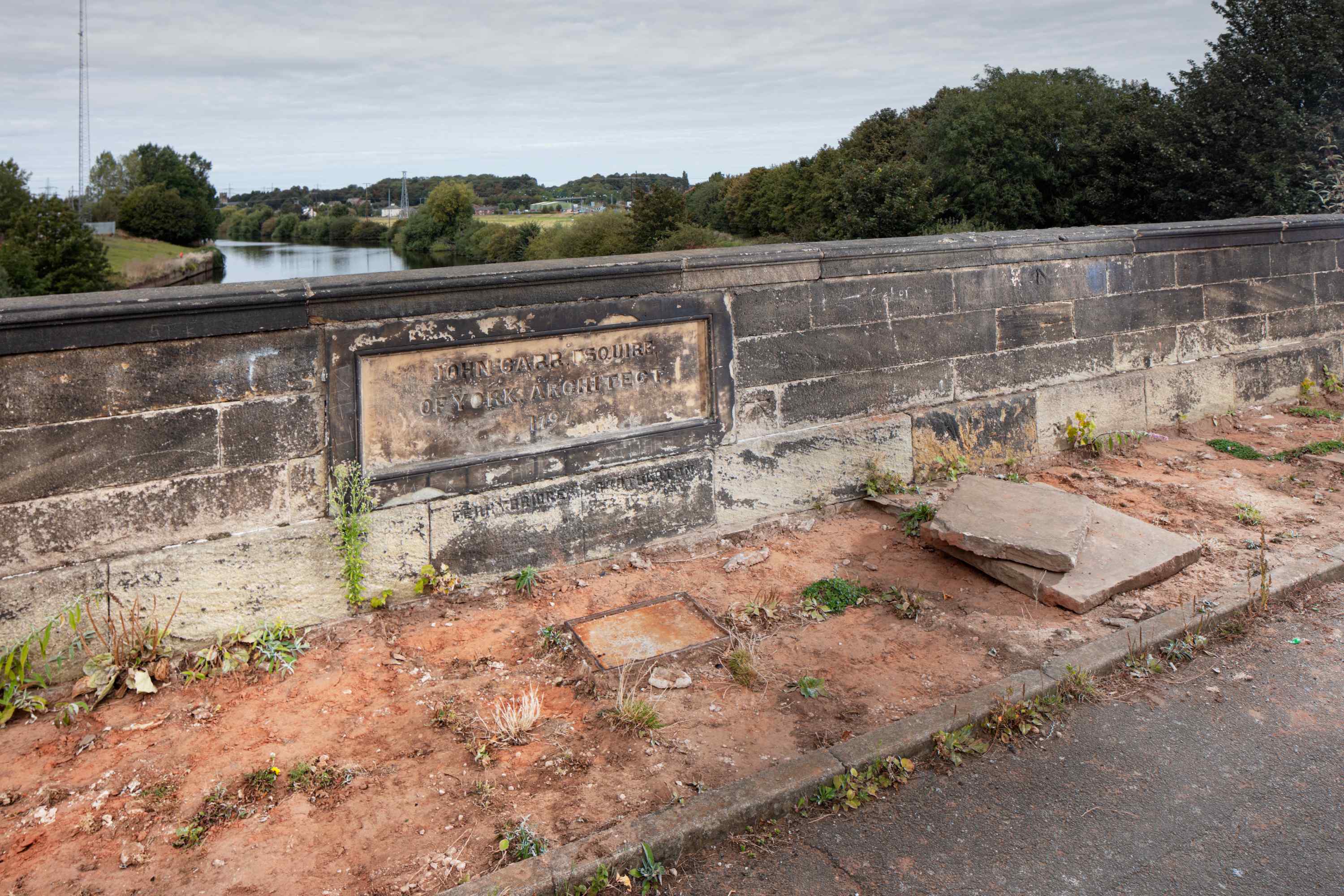 A bridge over a river with paving slabs missing