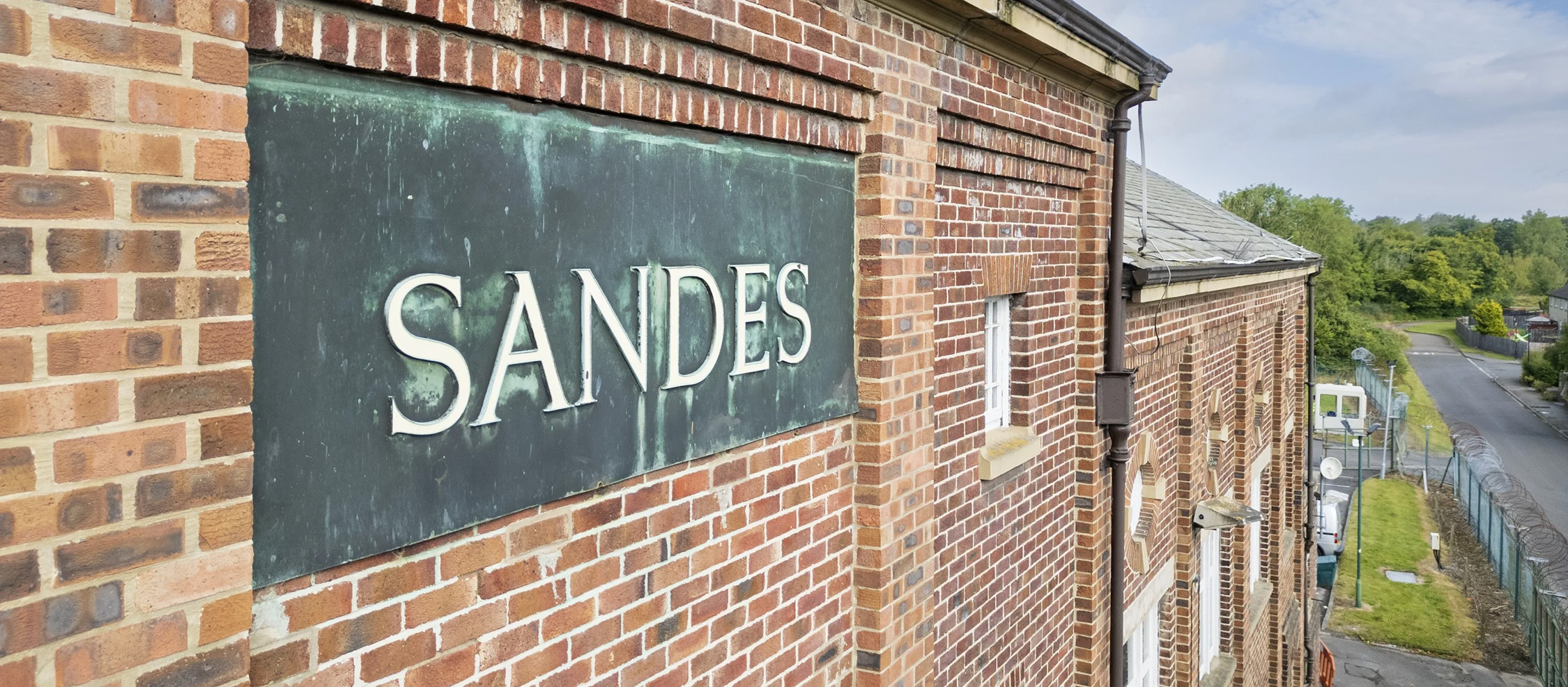 A close up of a signed in a brick building. 