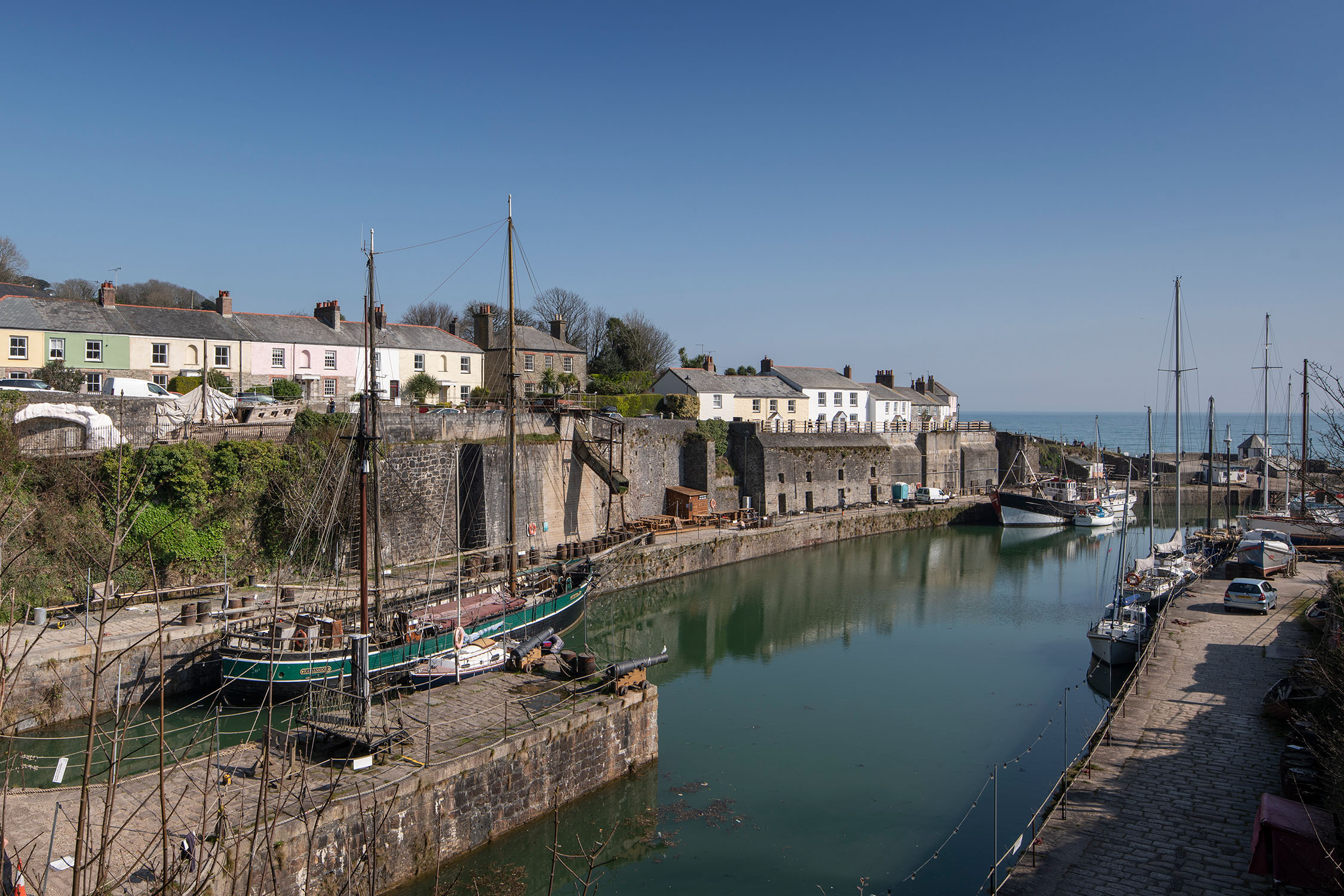 A ship moored at a harbour in Cornwall, UK.