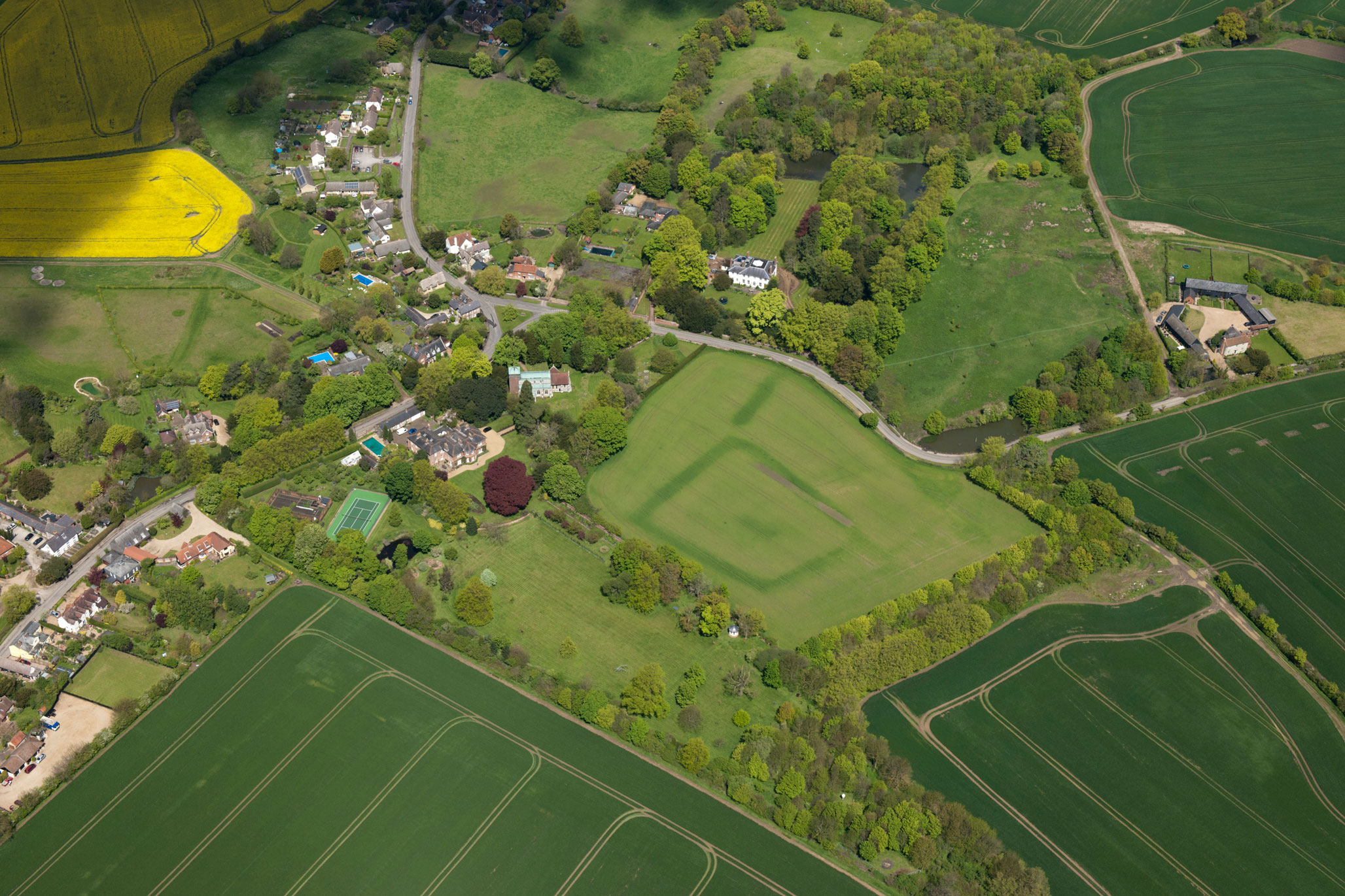 An aerial photograph showing standing buildings and cropmarks.