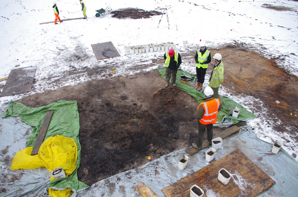 On-site archaeologists discussing methods for excavating an Iron Age furnace at Messingham.