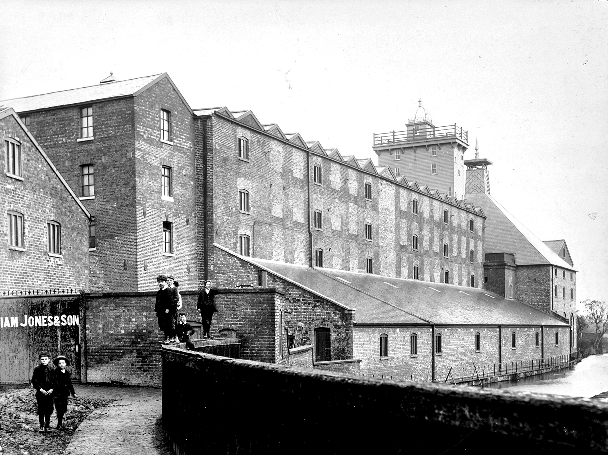 People standing next to the flaxmill