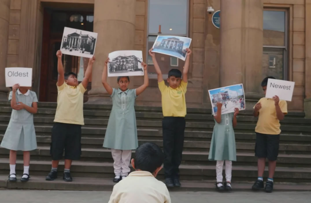 Children holding pictures above their heads
