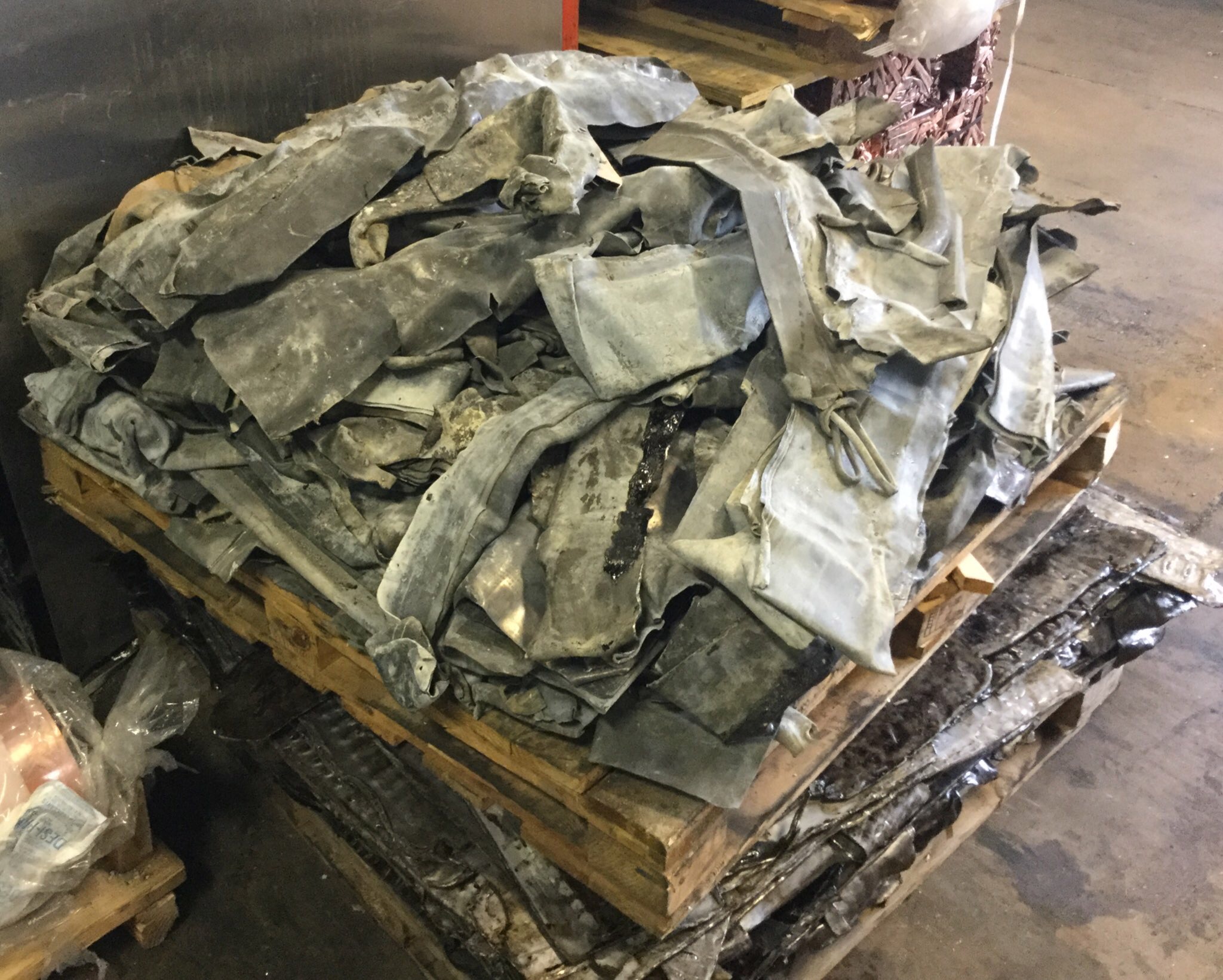 Photo of scrap lead stacked on a pallette at a recycling plant.