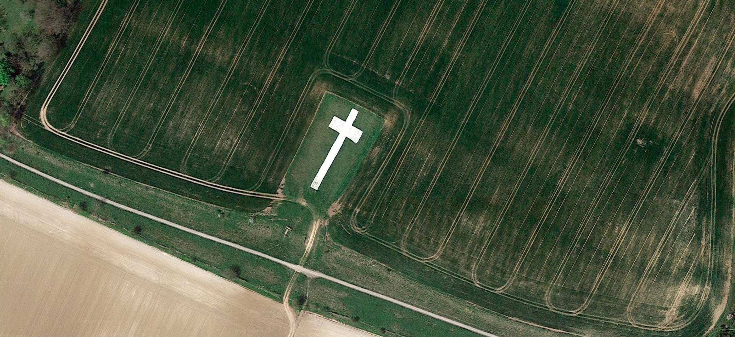 Aerial view of Lenham Cross War Memorial, a huge, 60 metre long chalk cross, isolated on the south facing slopes of the North Downs