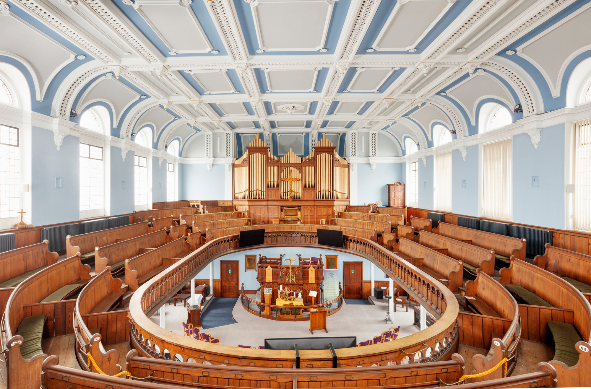 Grove Street Methodist Church interior looking across from the gallery, along wooden pews and towards the organ.