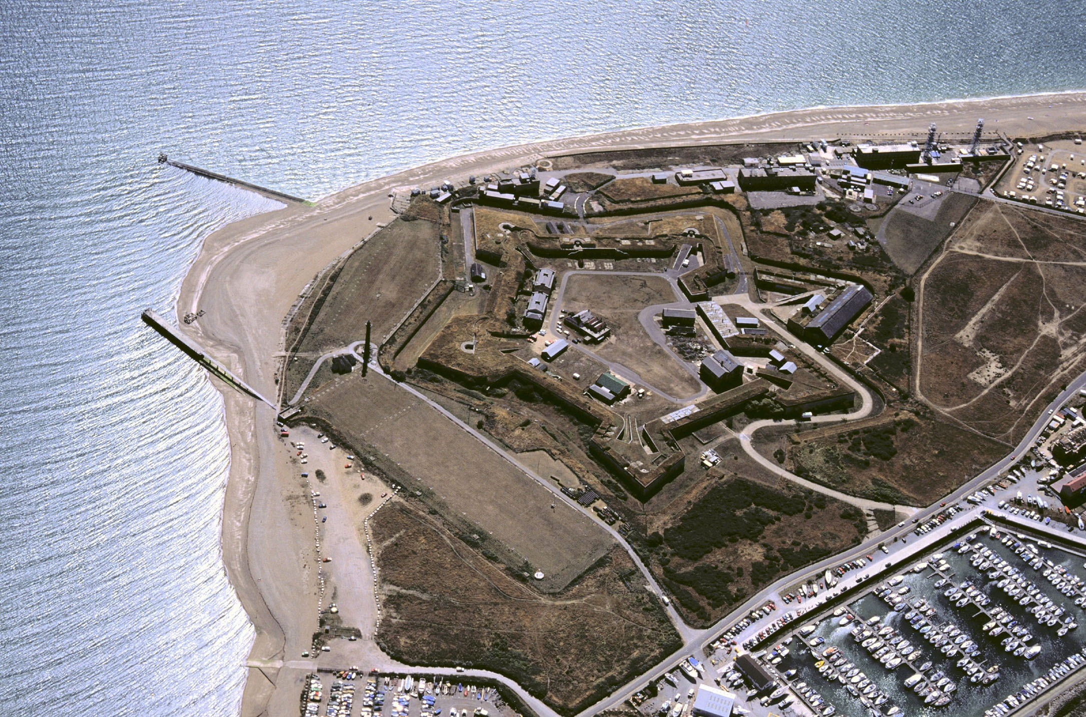 A birds-eye aerial view of a research facility surrounded by the sea
