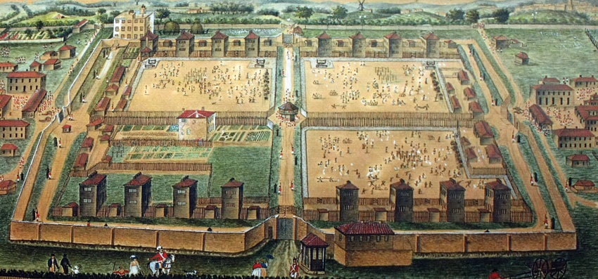 Painting of the Norman Cross Prisoner of War Camp as it would have been when in use, with perimeter walls, barrack buildings, and exercise yards for the prisoners.