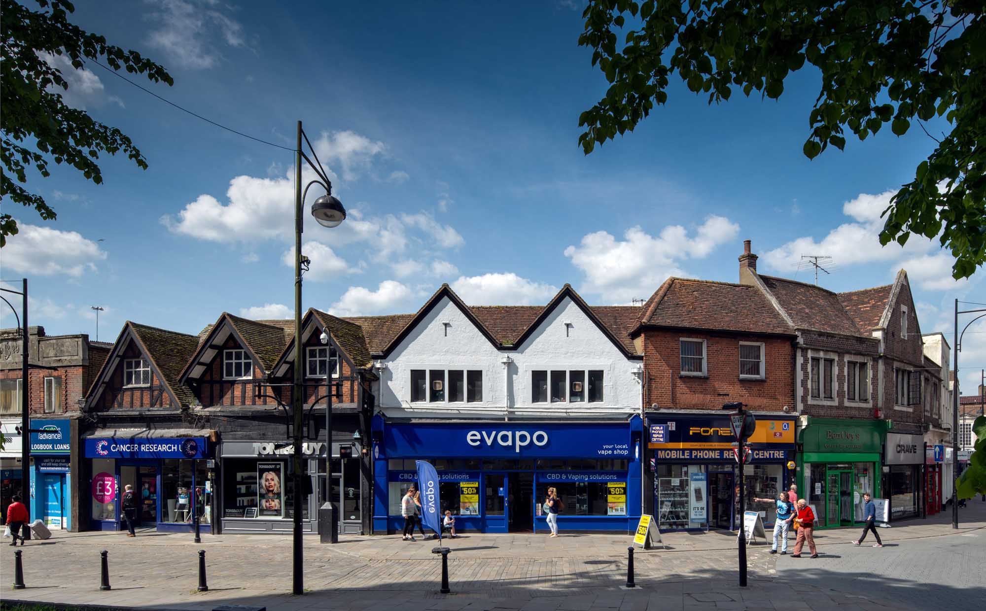 Shops and shoppers on a sunny day on Church Street, High Wycombe.