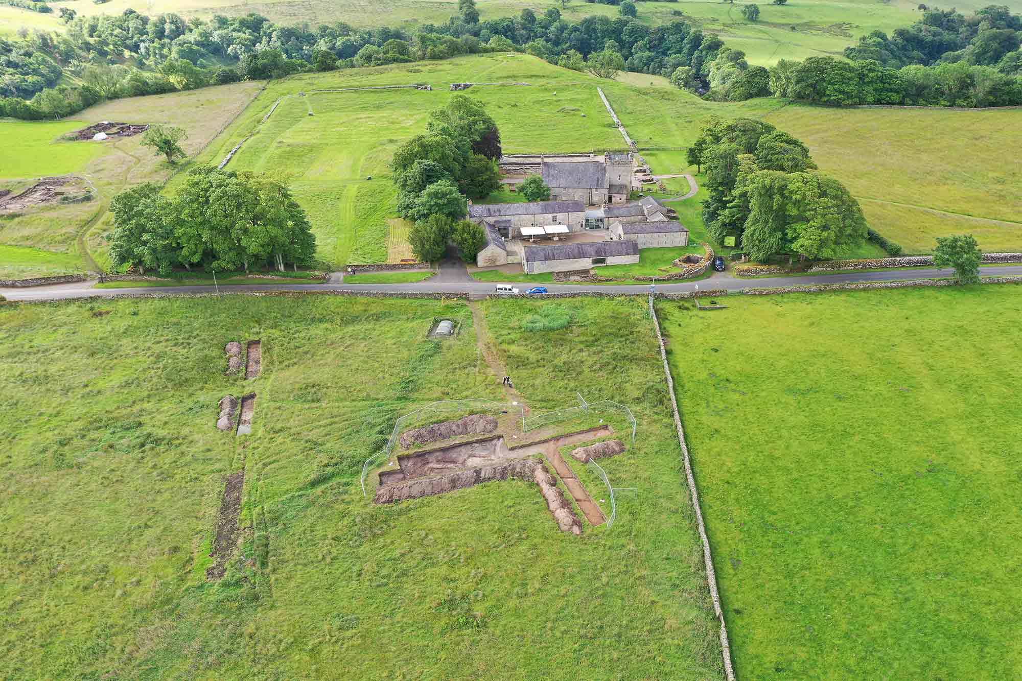 Aerial view of excavations with buildings in the background