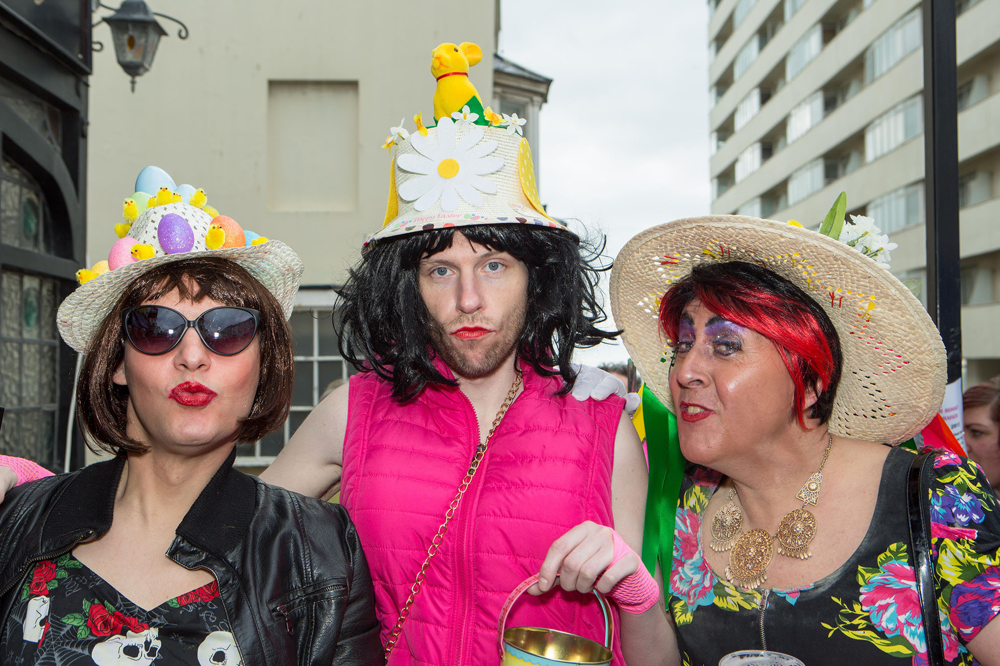 Group of three wearing Easter bonnets and pouting for the camera.